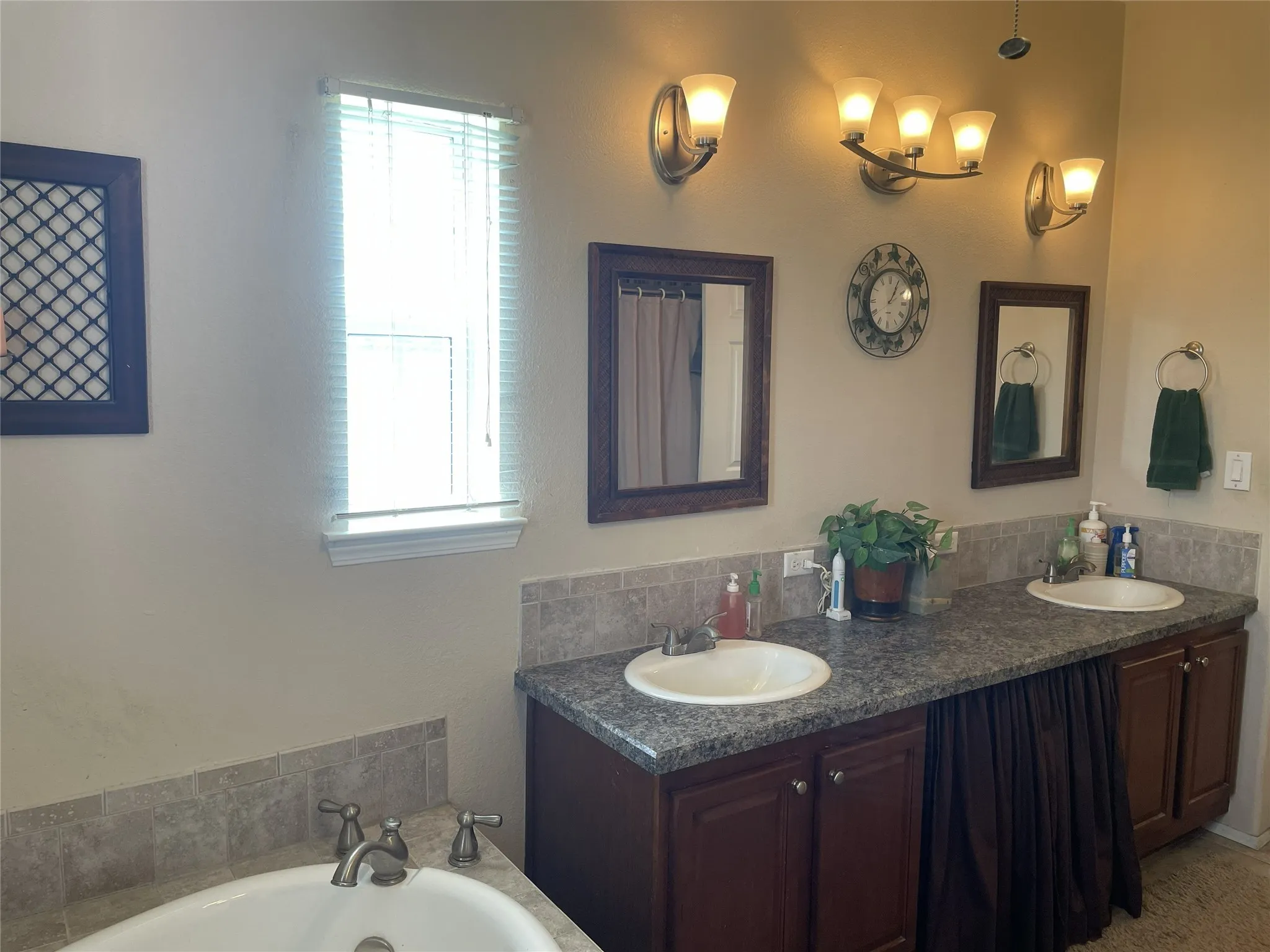 Dual vanity & the jetted tub has a custom faucet