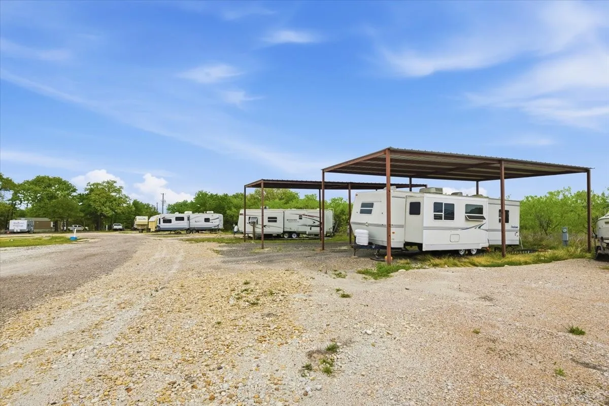 View of parking featuring a detached carport