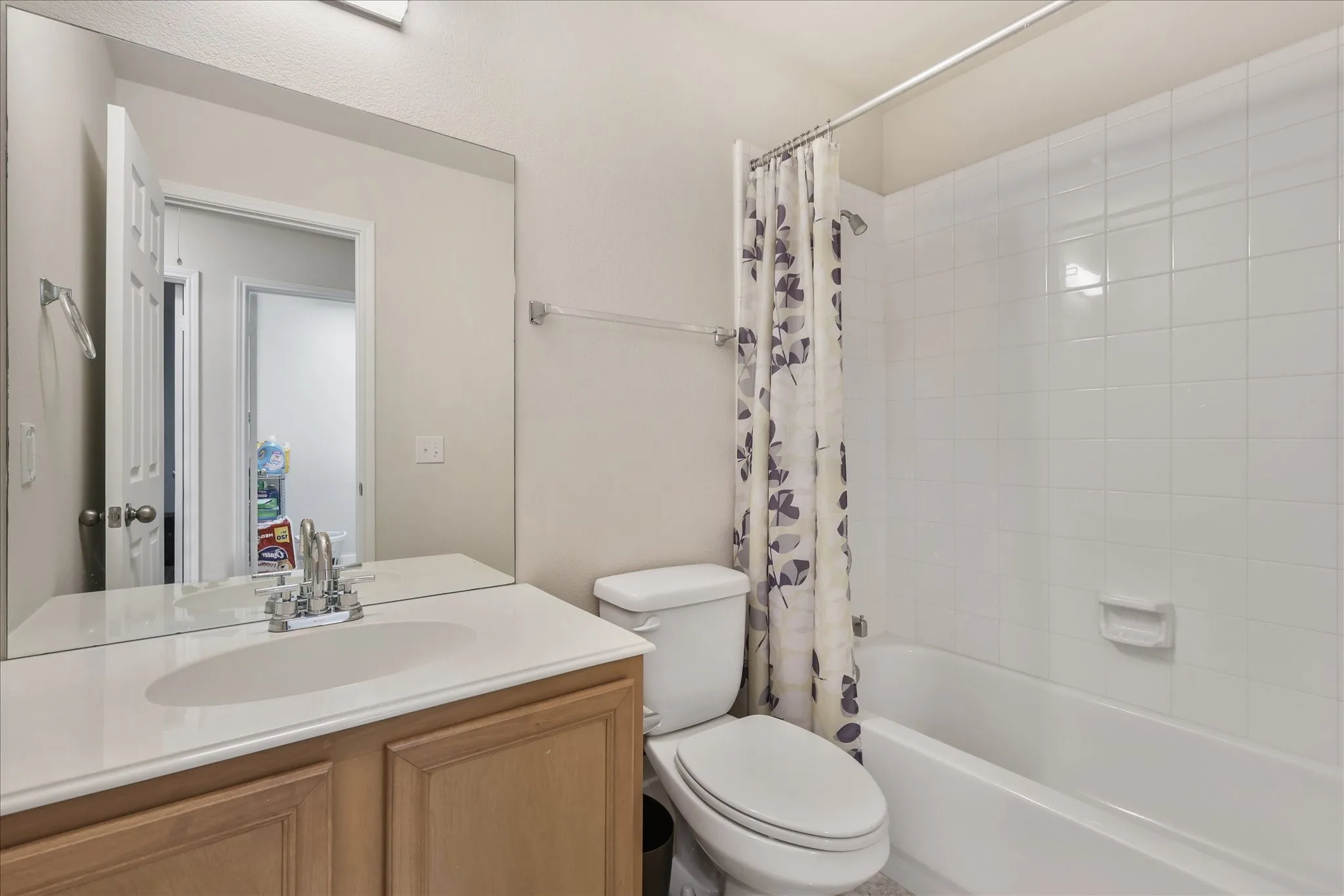 Bathroom with vanity and shower / bathtub combination with curtain