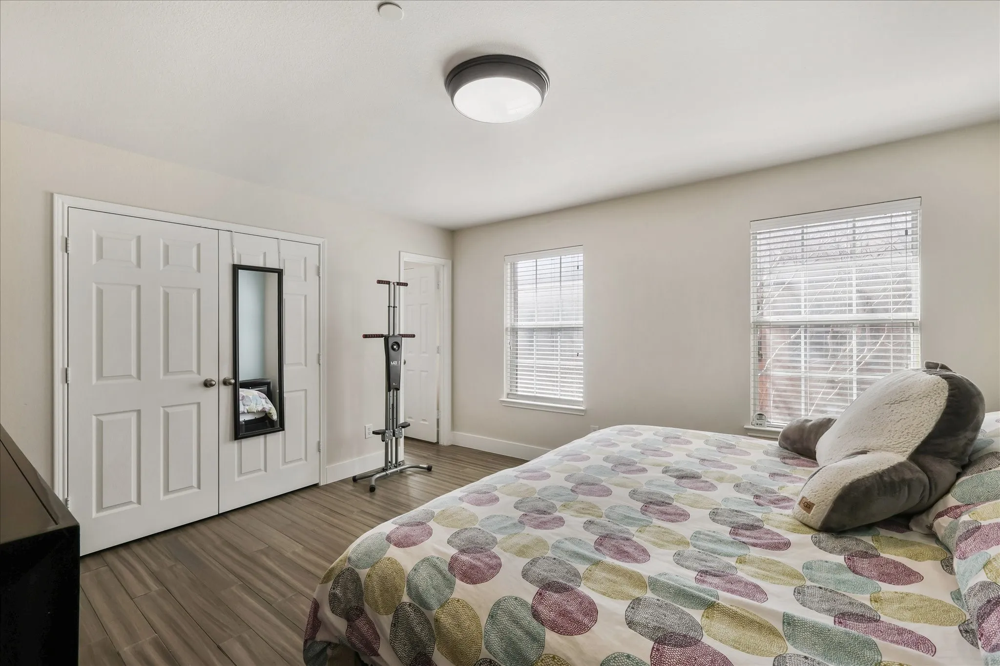 Bedroom featuring dark wood-type flooring and a closet
