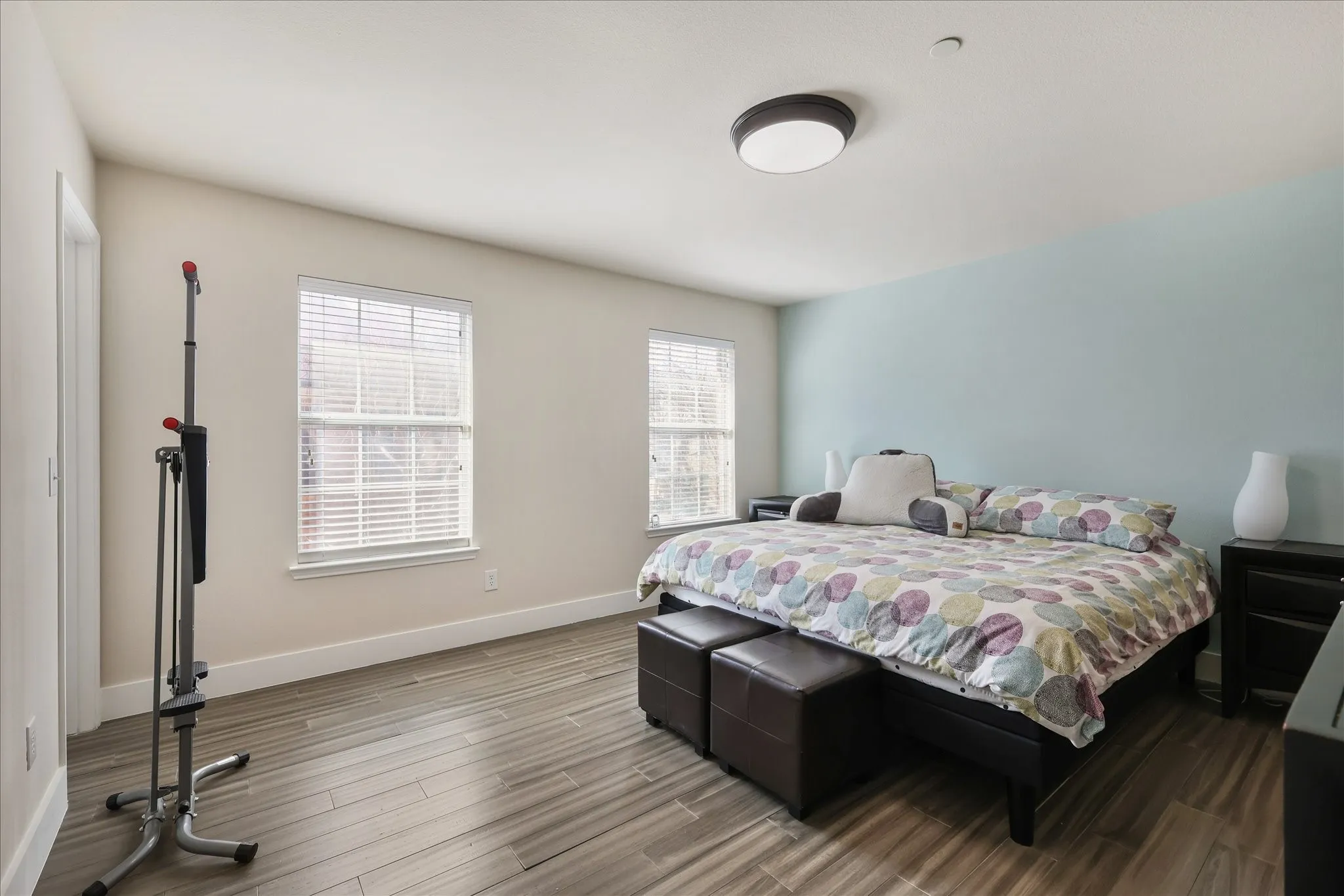 Bedroom featuring wood finished floors and baseboards