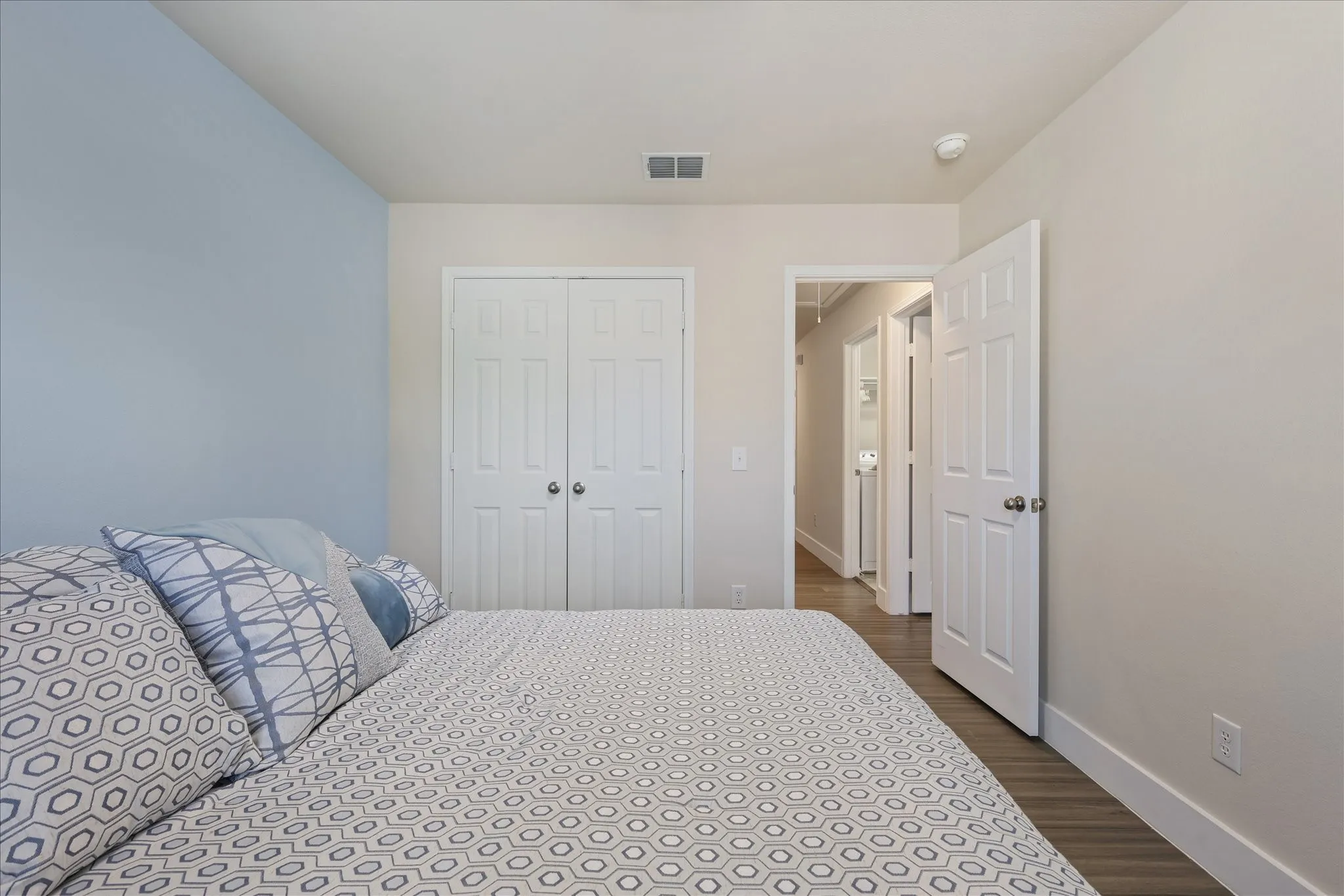 Bedroom featuring dark wood-type flooring and a closet