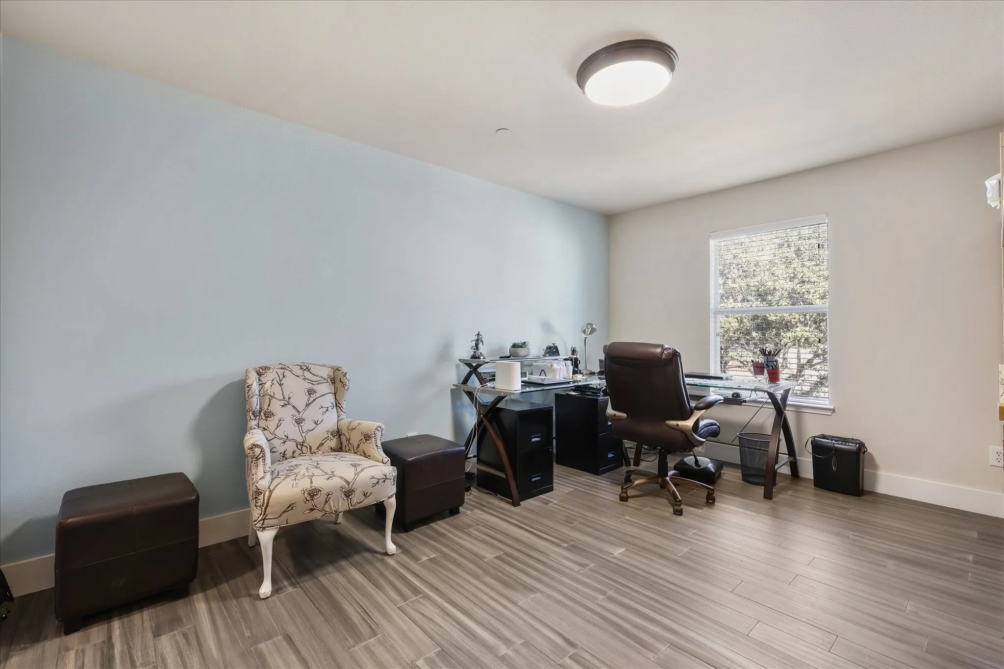Office area with baseboards and wood finished floors