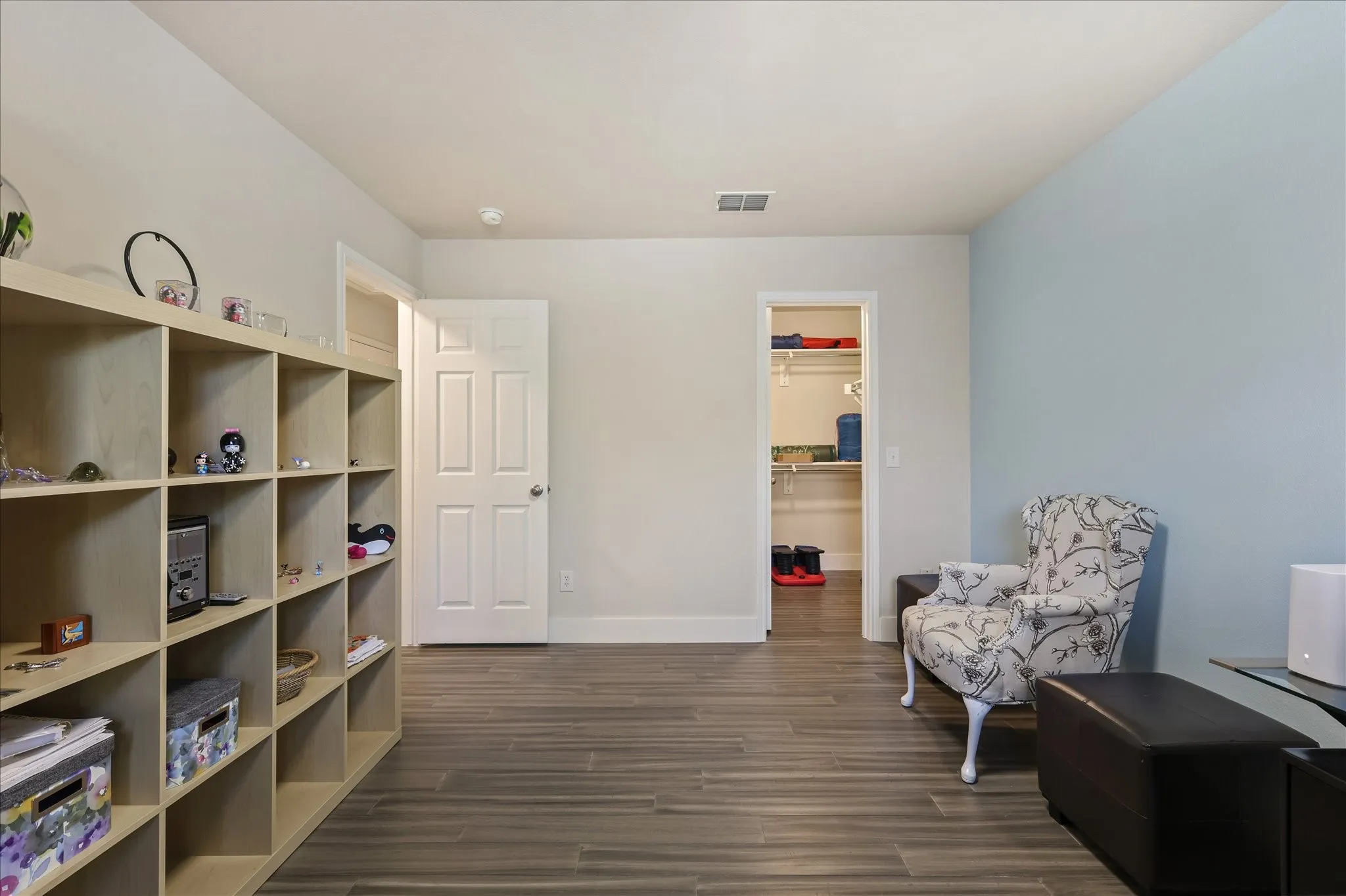 Sitting room featuring dark wood-type flooring and baseboards