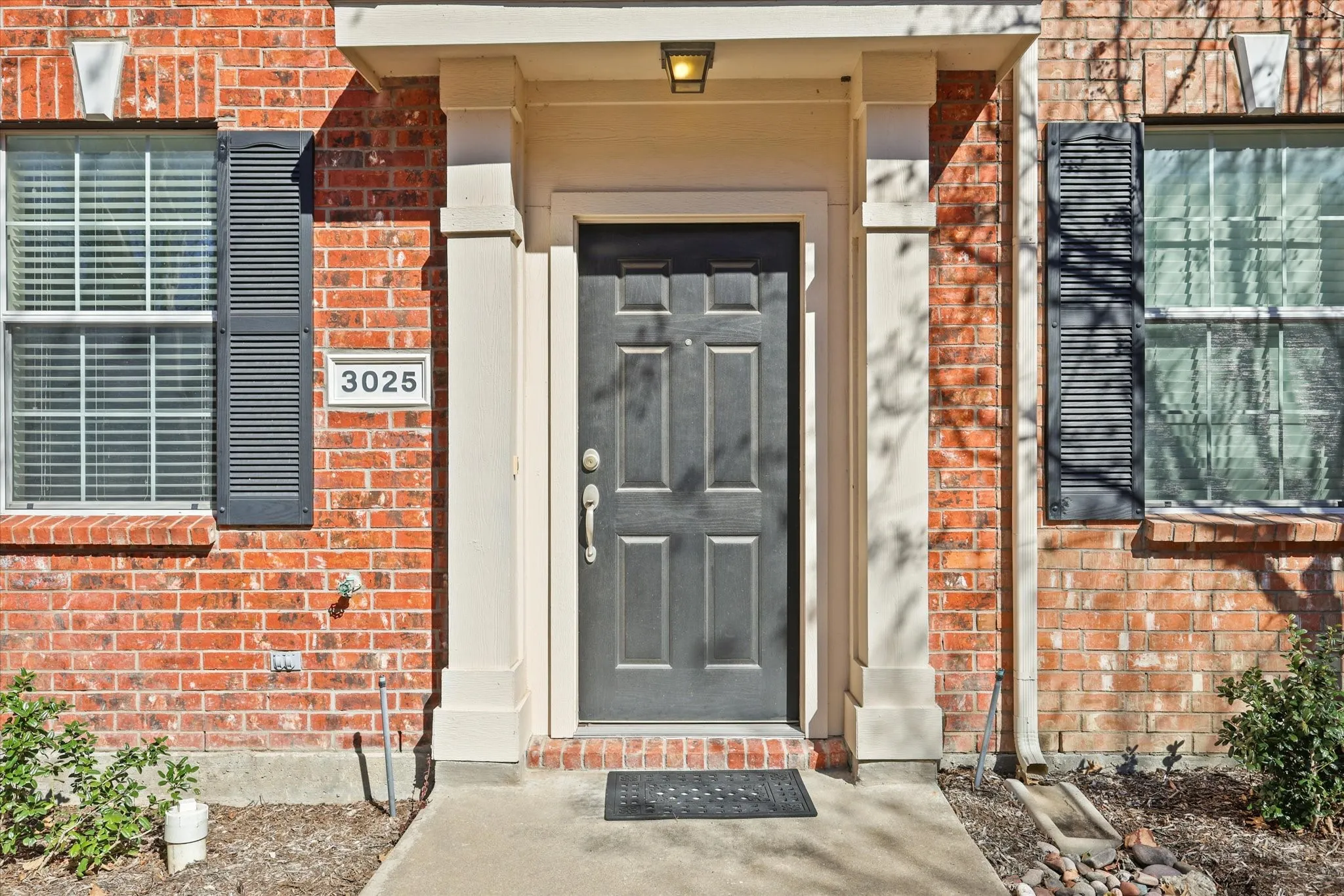 Doorway to property featuring brick siding