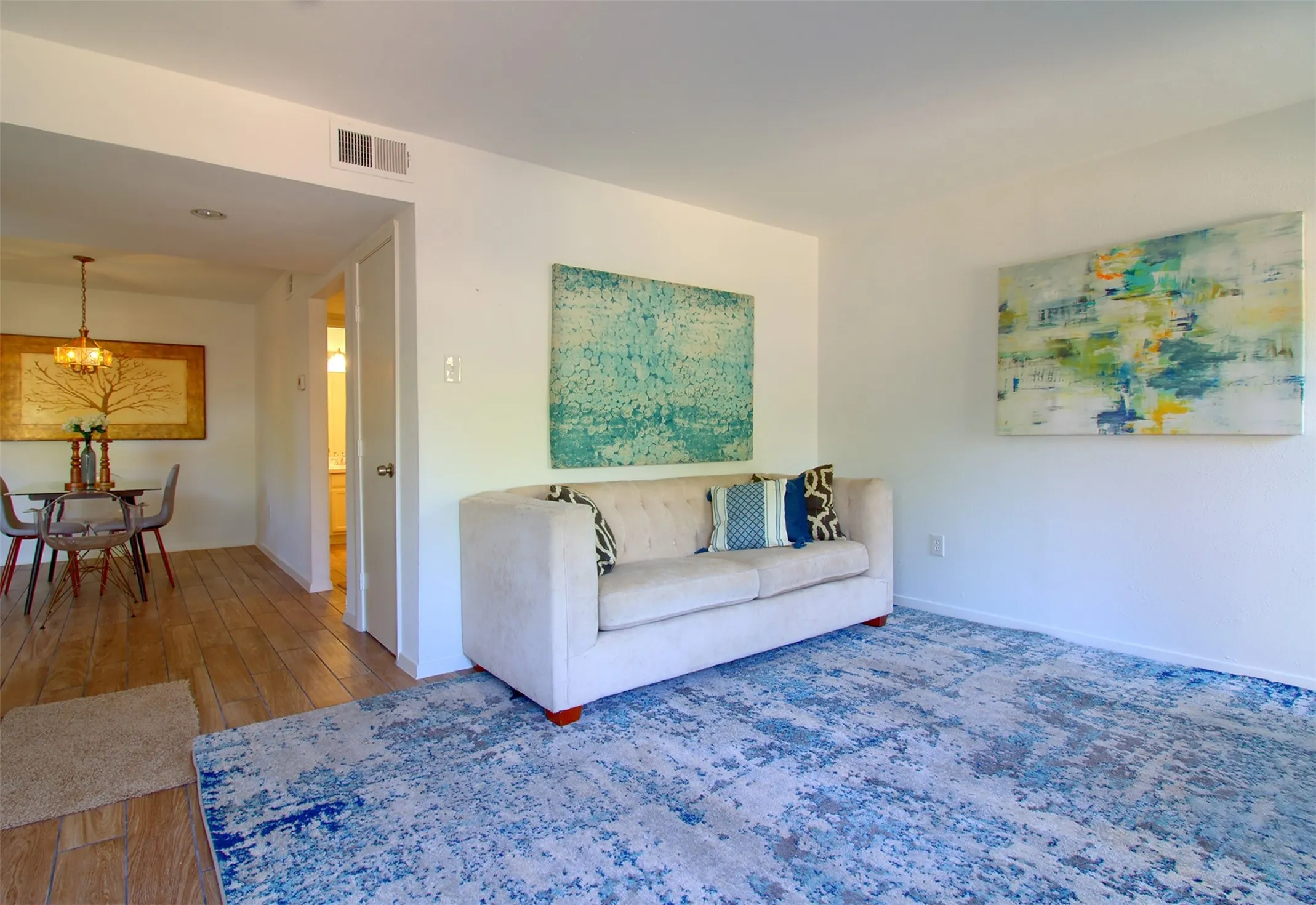 Living area with hardwood / wood-style floors and baseboards