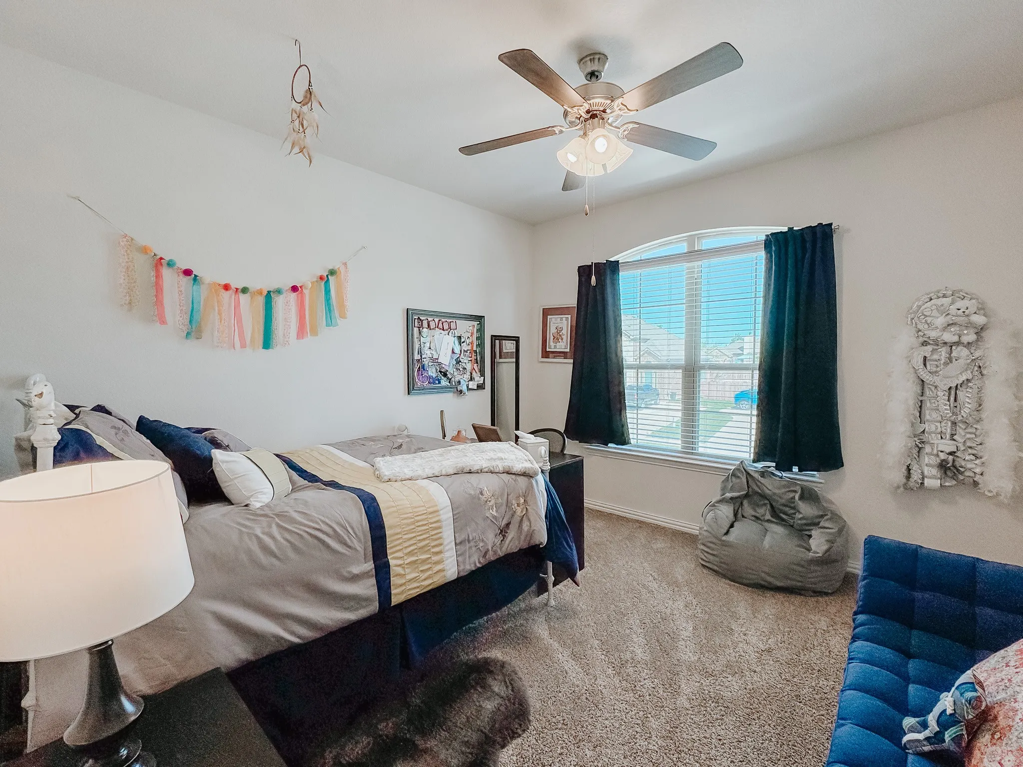 Carpeted bedroom with ceiling fan
