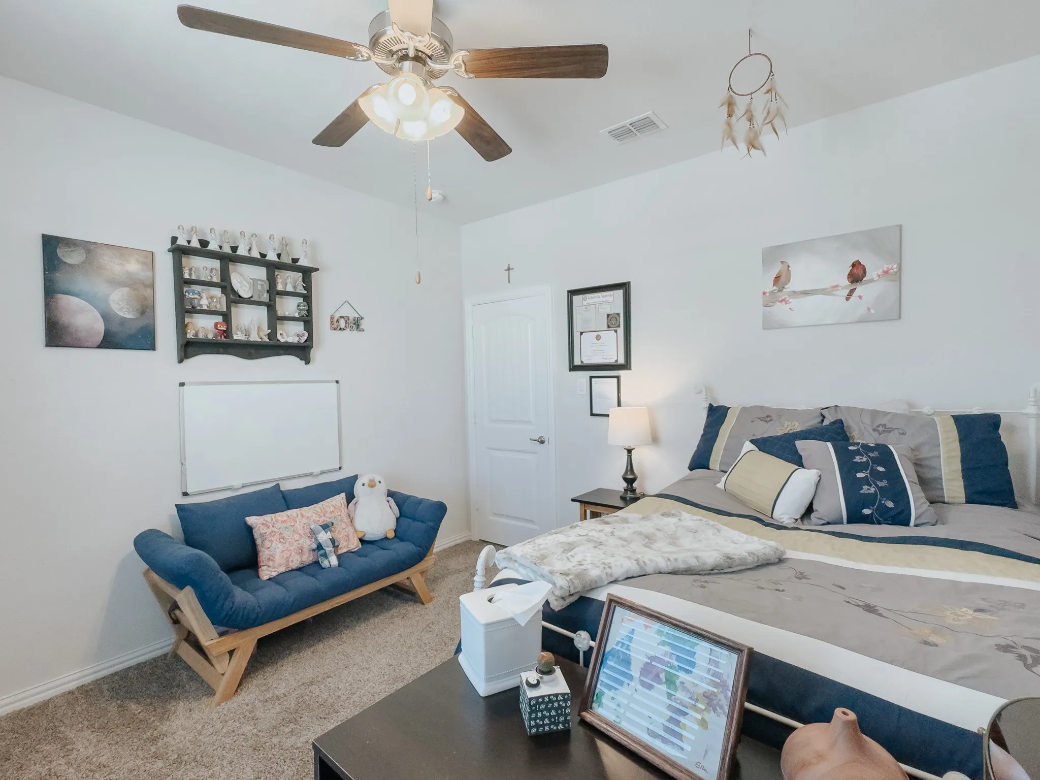 Carpeted upstairs bedroom with ceiling fan