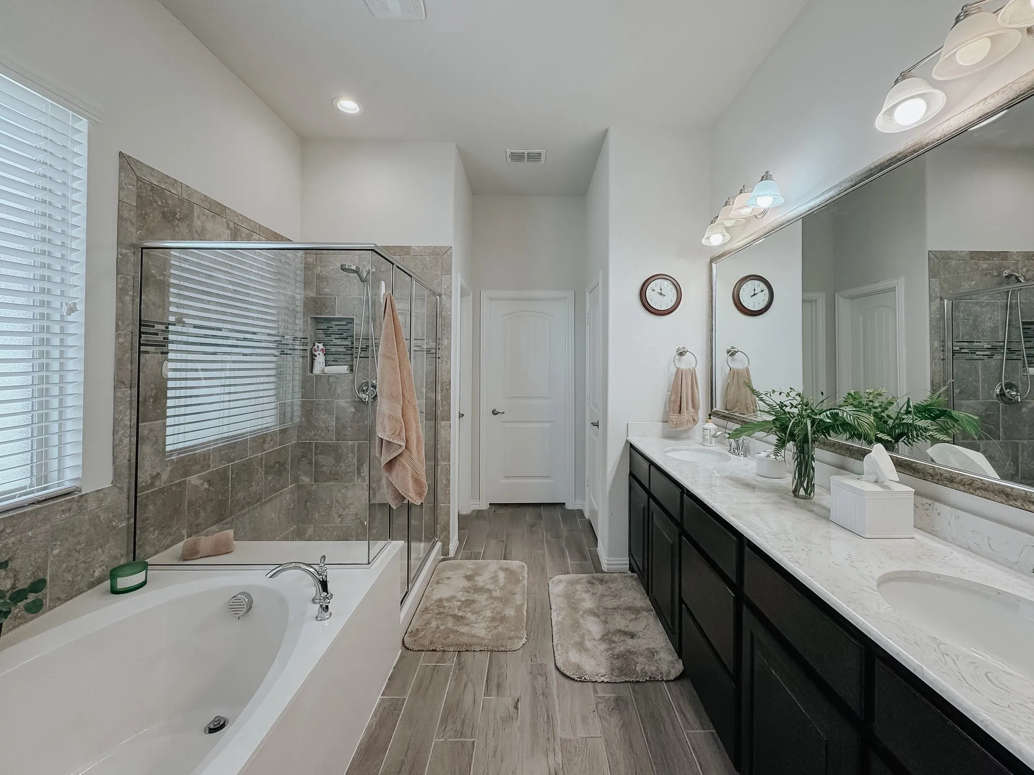 Bathroom (primary) featuring large vanity, dual sinks, and plus walk in shower with nice size tub.