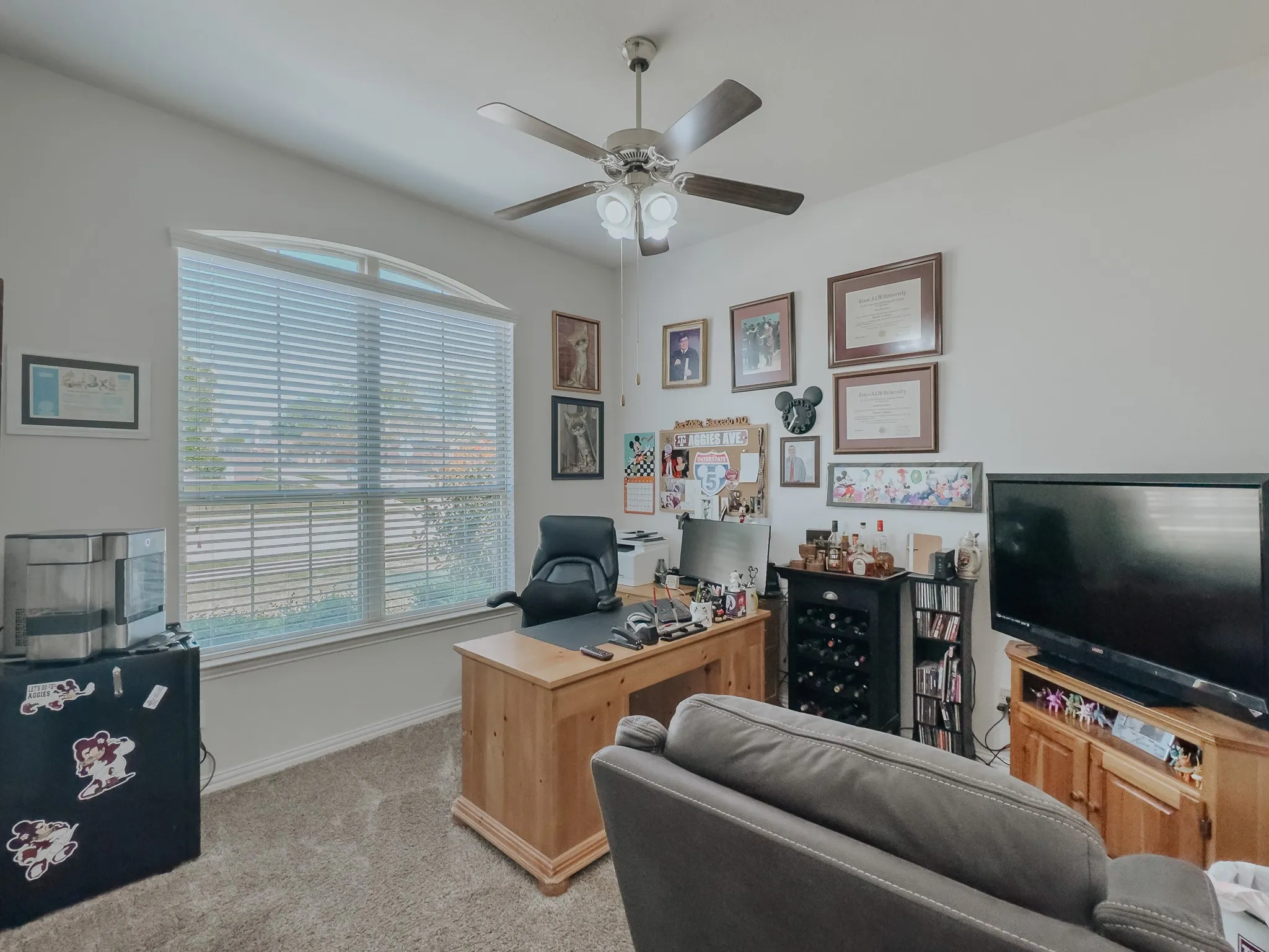Office featuring ceiling fan and light carpet or can be an extra bedroom .. front of home