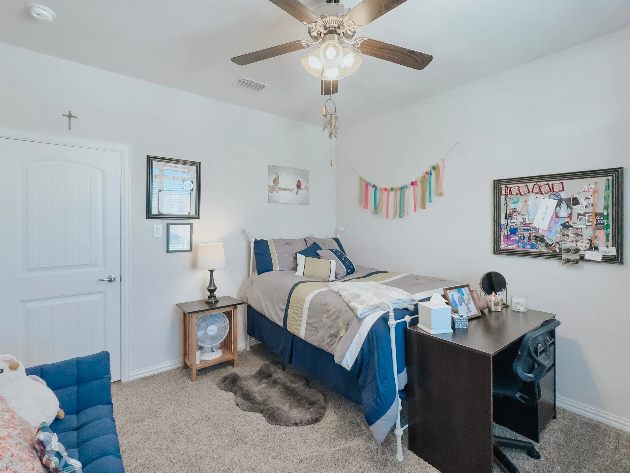 Carpeted  -upstairs bedroom featuring ceiling fan