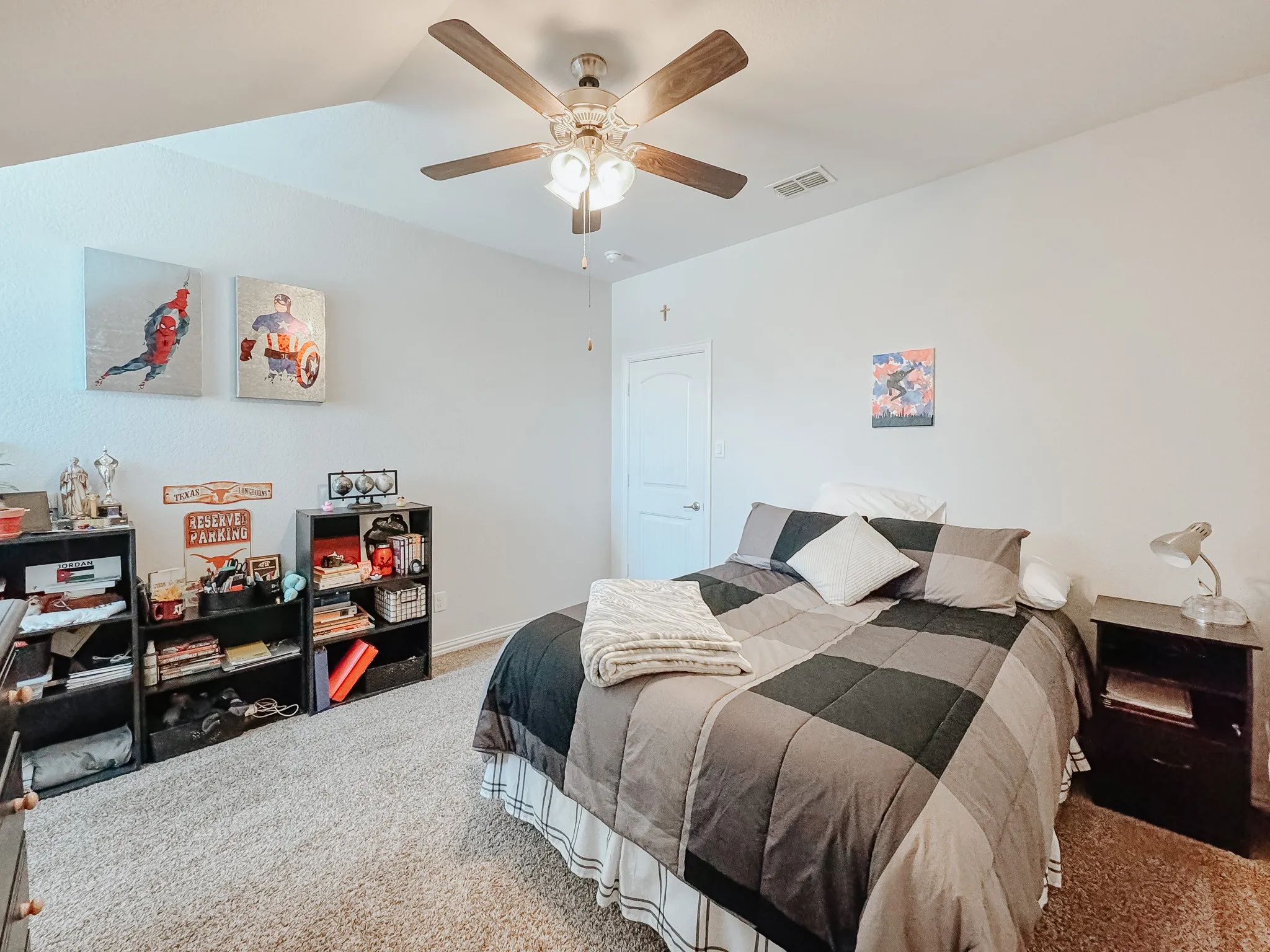 Bedroom upstairs featuring light carpet and ceiling fan