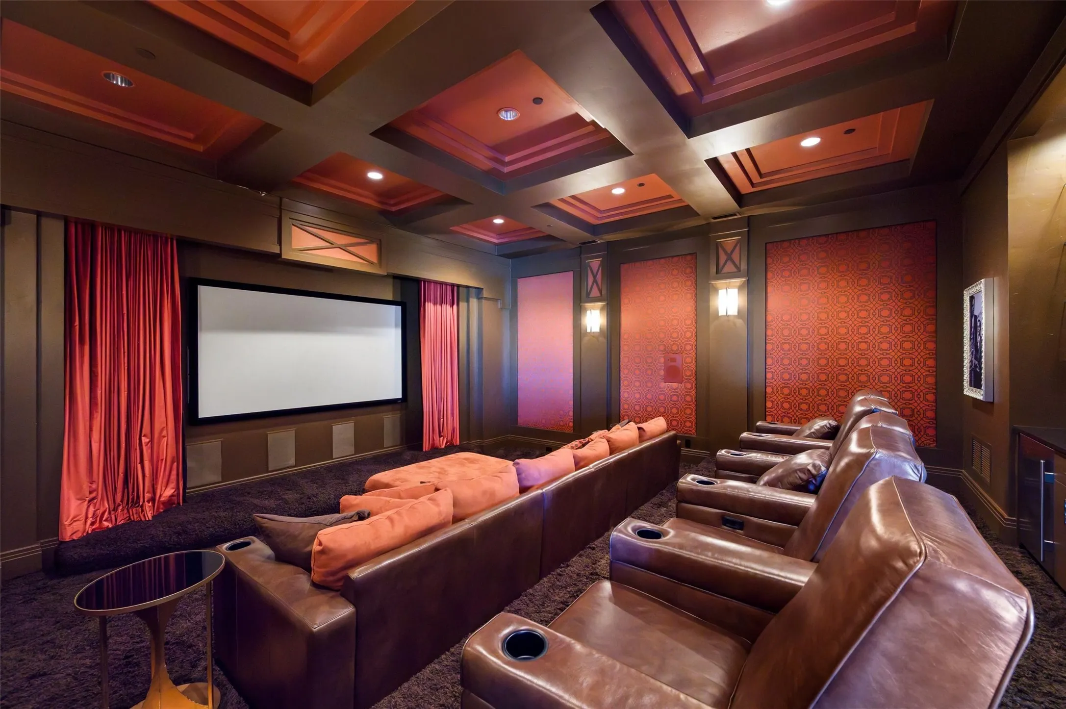 Home theater featuring tiered seating and a dry bar