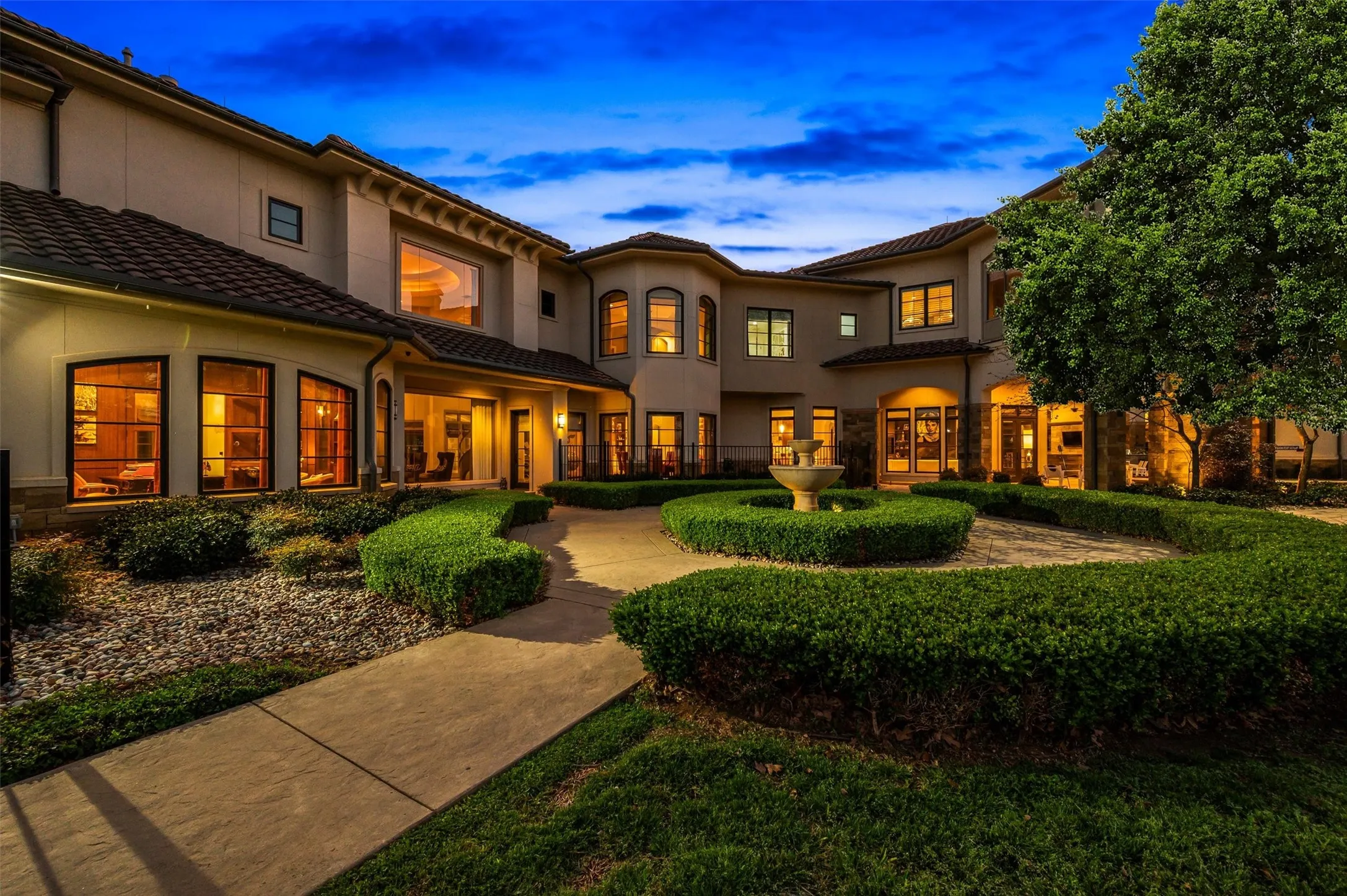 View of court yard and back of home at dusk
