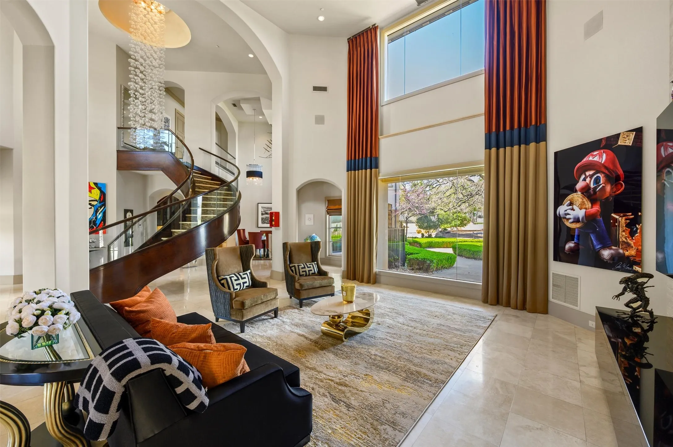 Formal Living area with a high ceiling, arched walkways, And a floating staircase