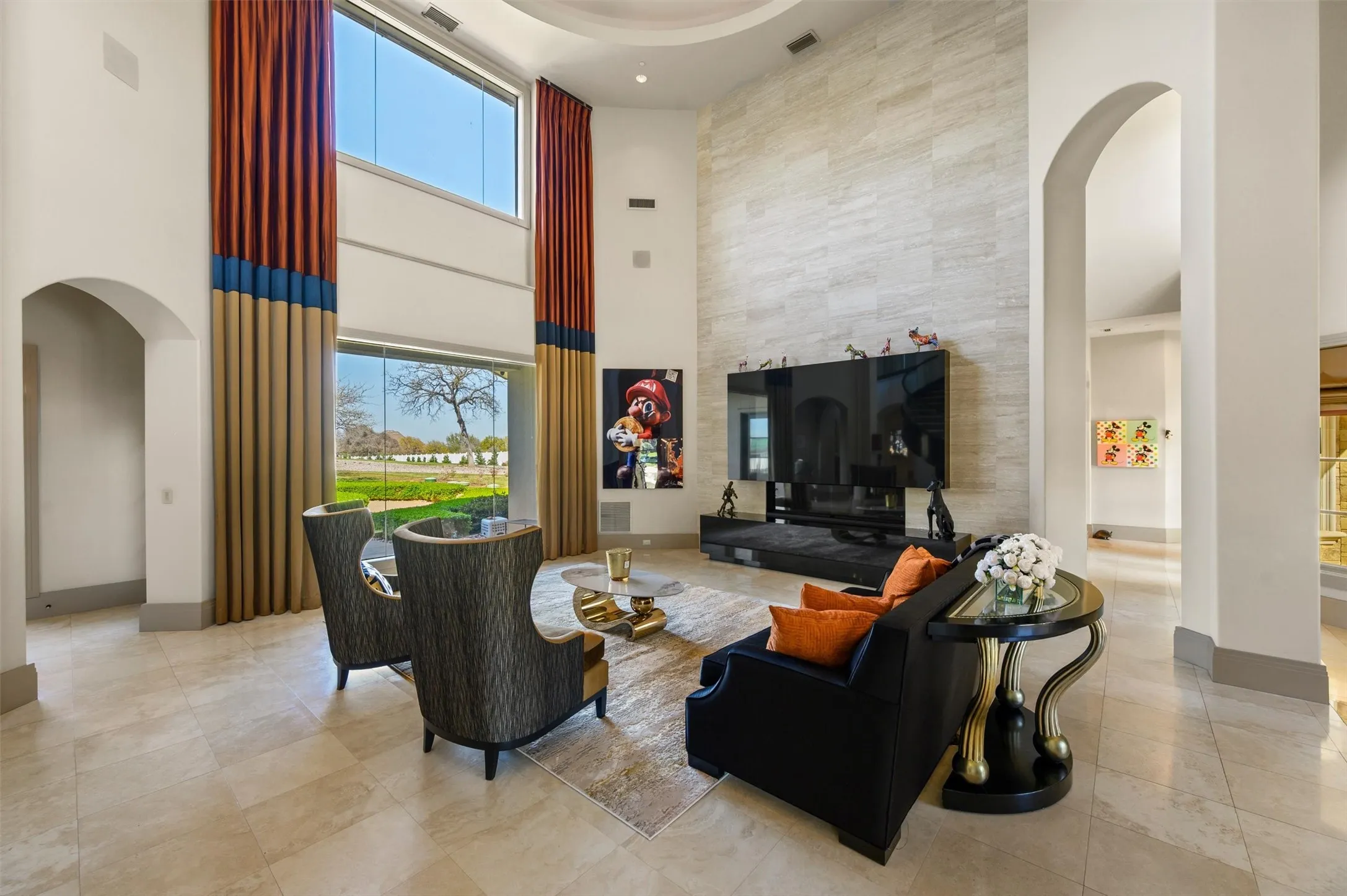 Formal Living area with arched walkways, a high ceiling, and plenty of natural light