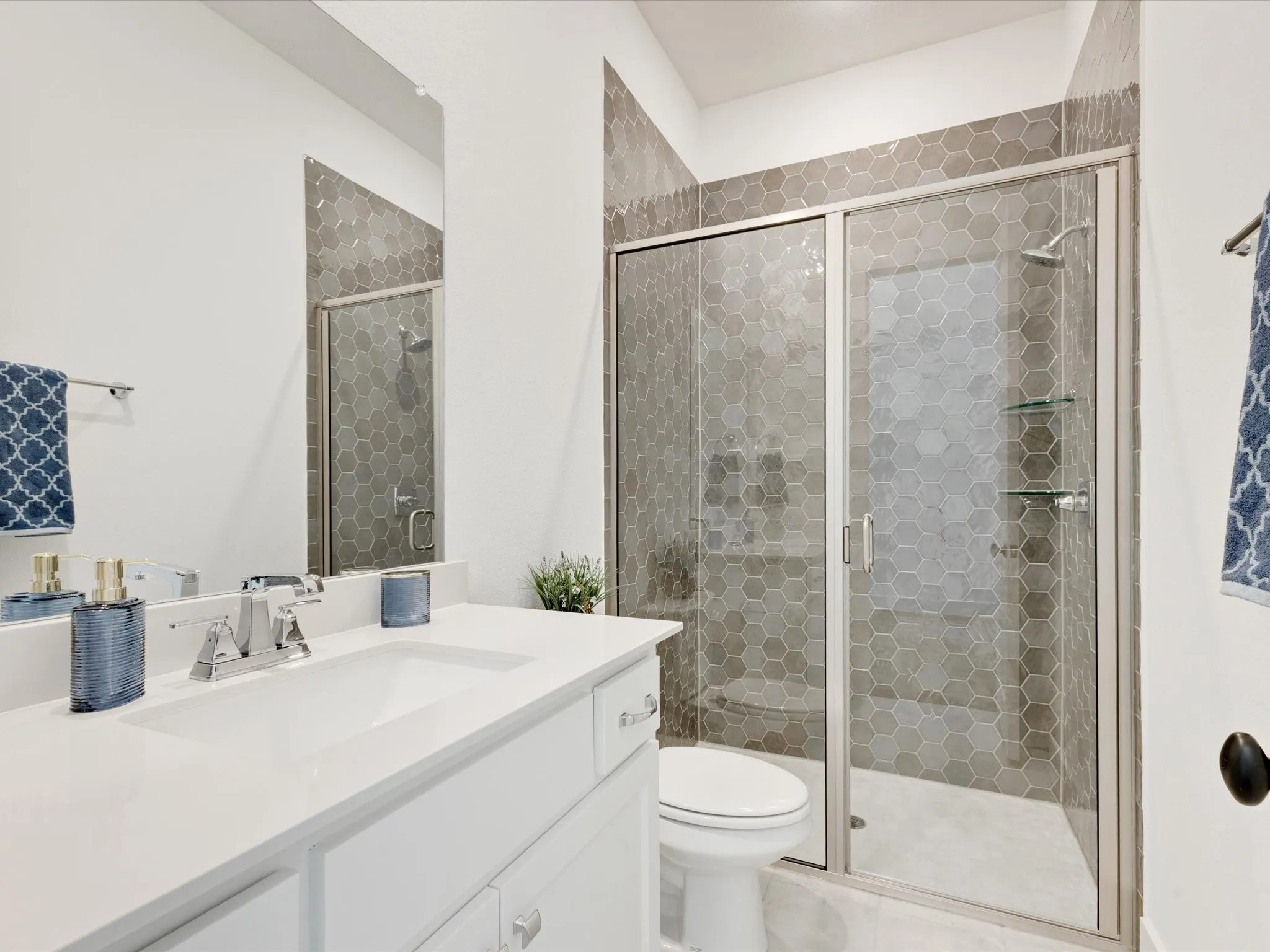 Bathroom featuring vanity and a shower stall