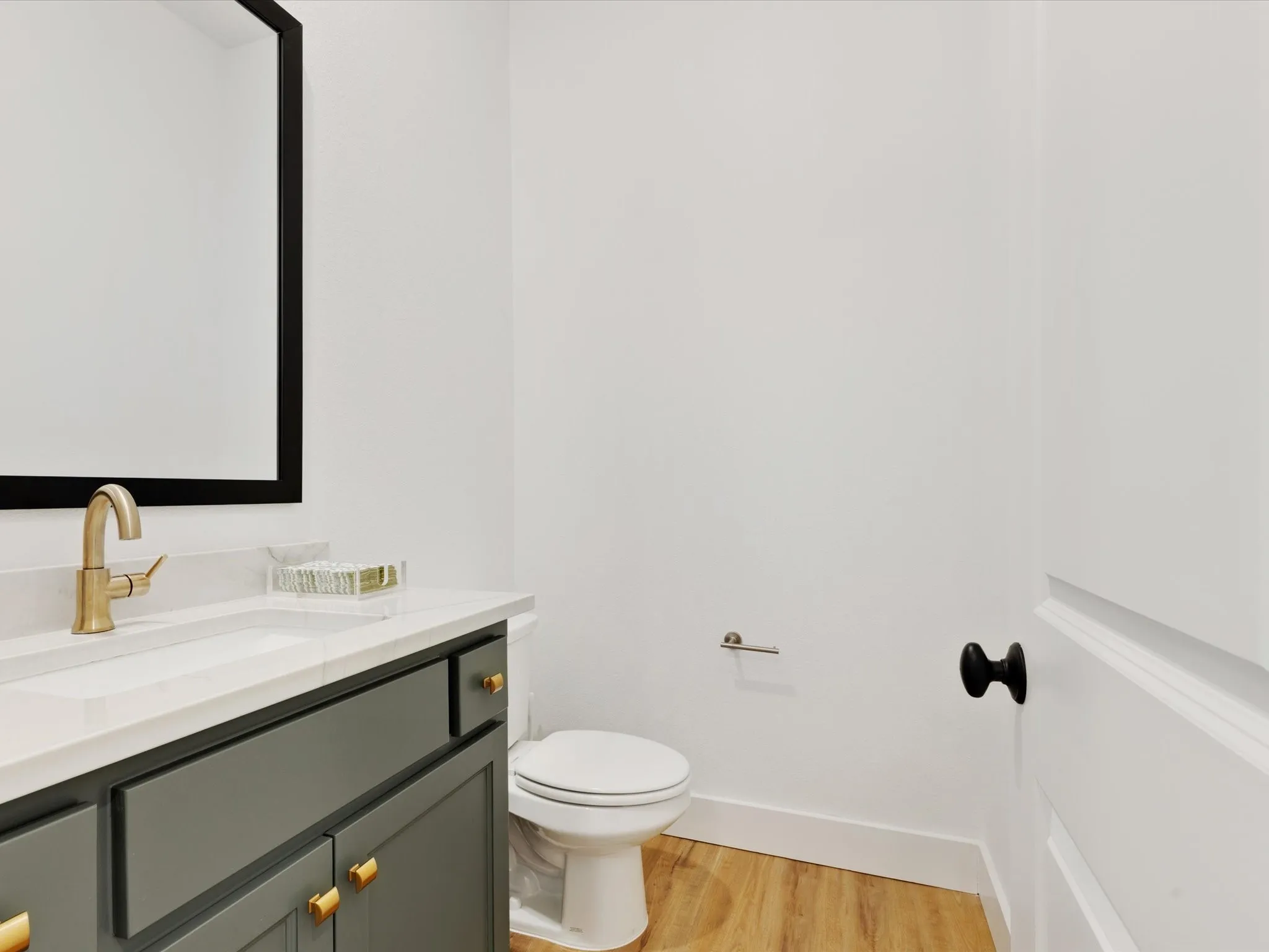 Half bath with vanity and light wood-type flooring