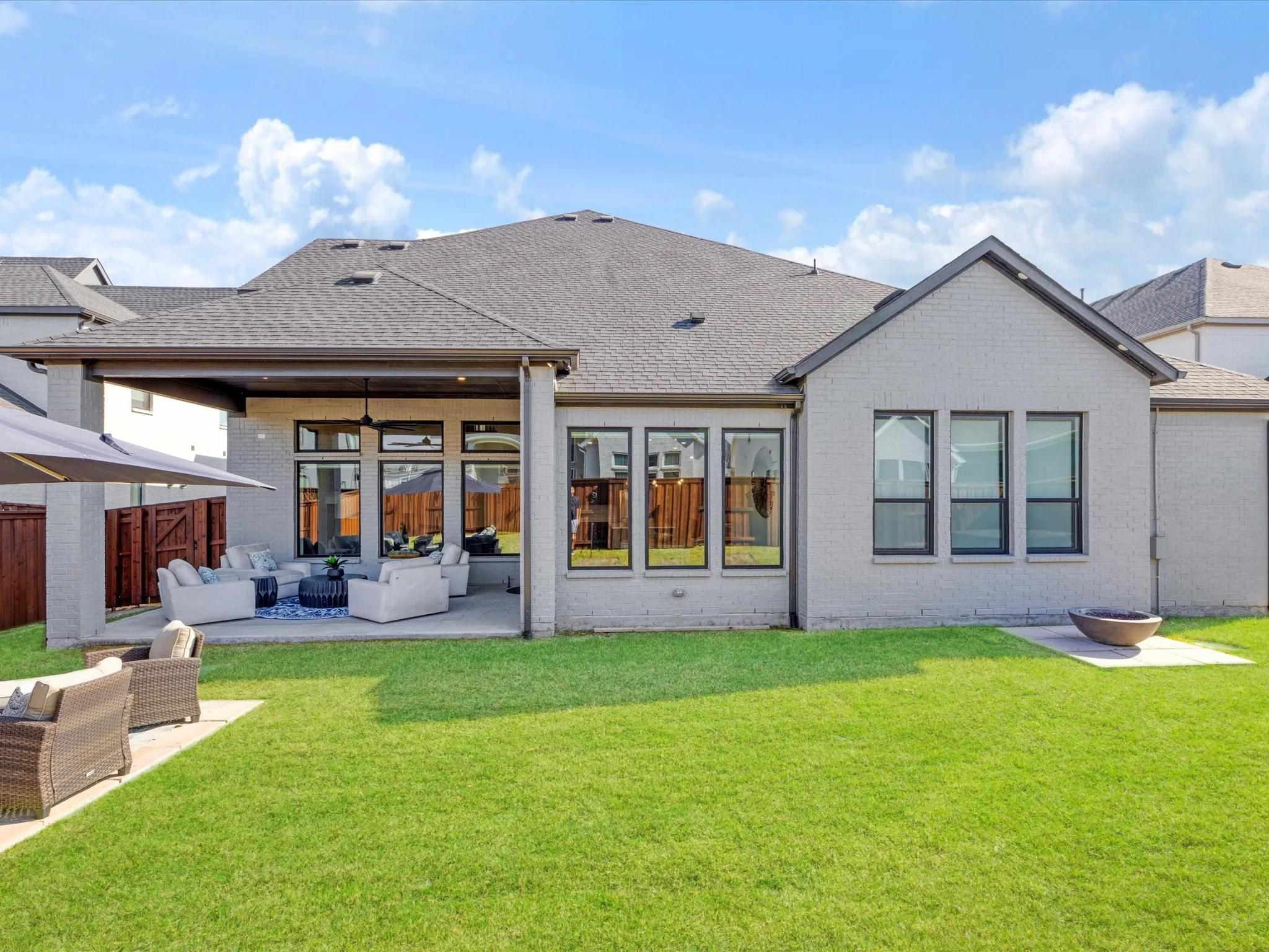 Rear view of property with an outdoor hangout area, a patio area, and a shingled roof