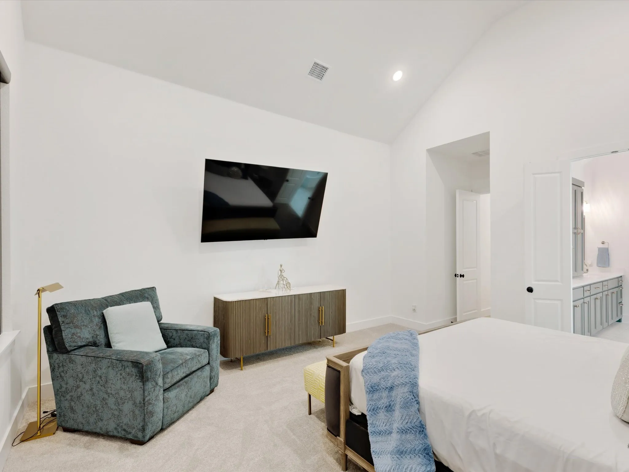  Primary Bedroom featuring lofted ceiling, recessed lighting, light colored carpet, and ensuite bathroom