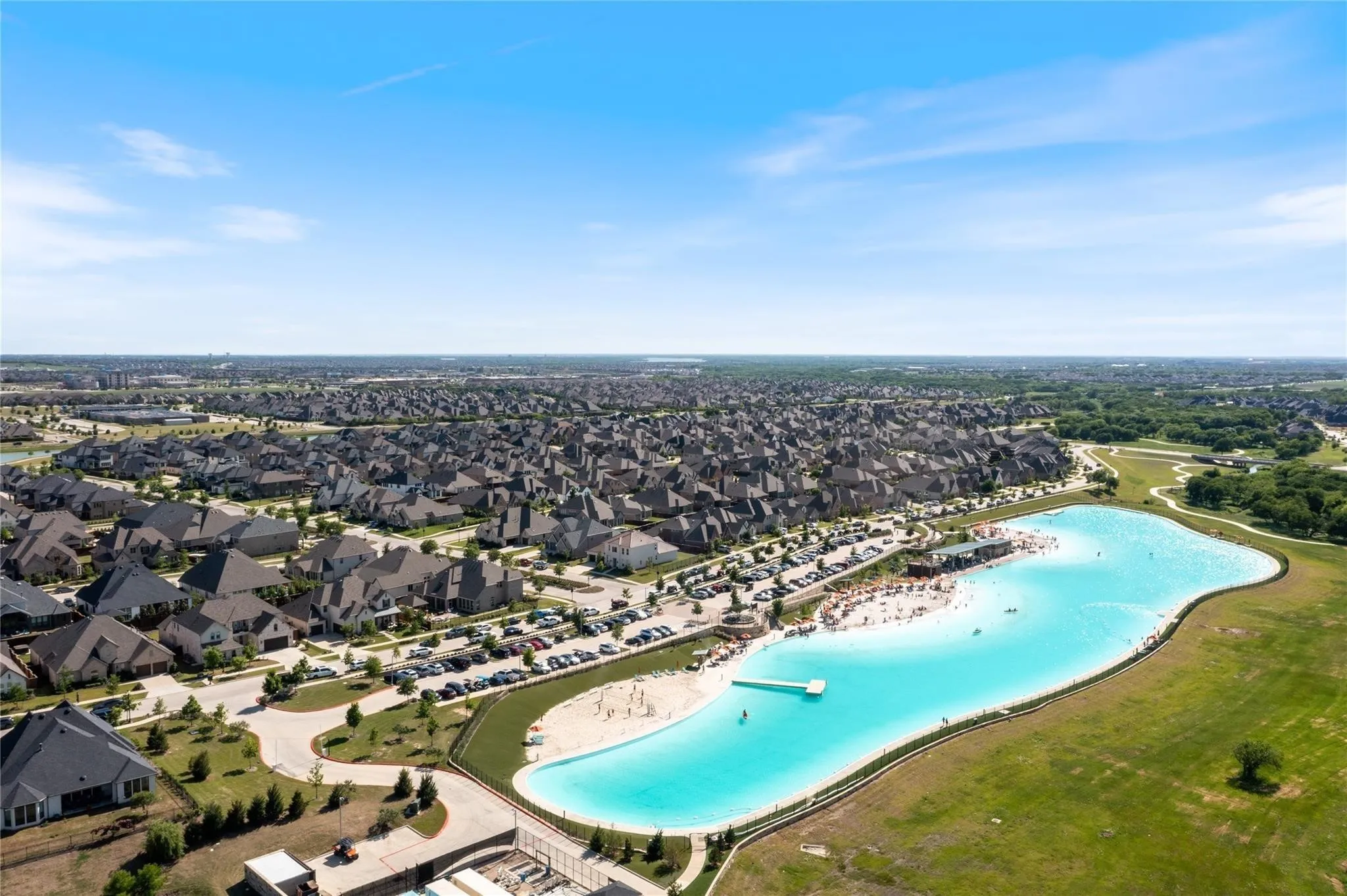 Aerial perspective of suburban area featuring a nearby body of water