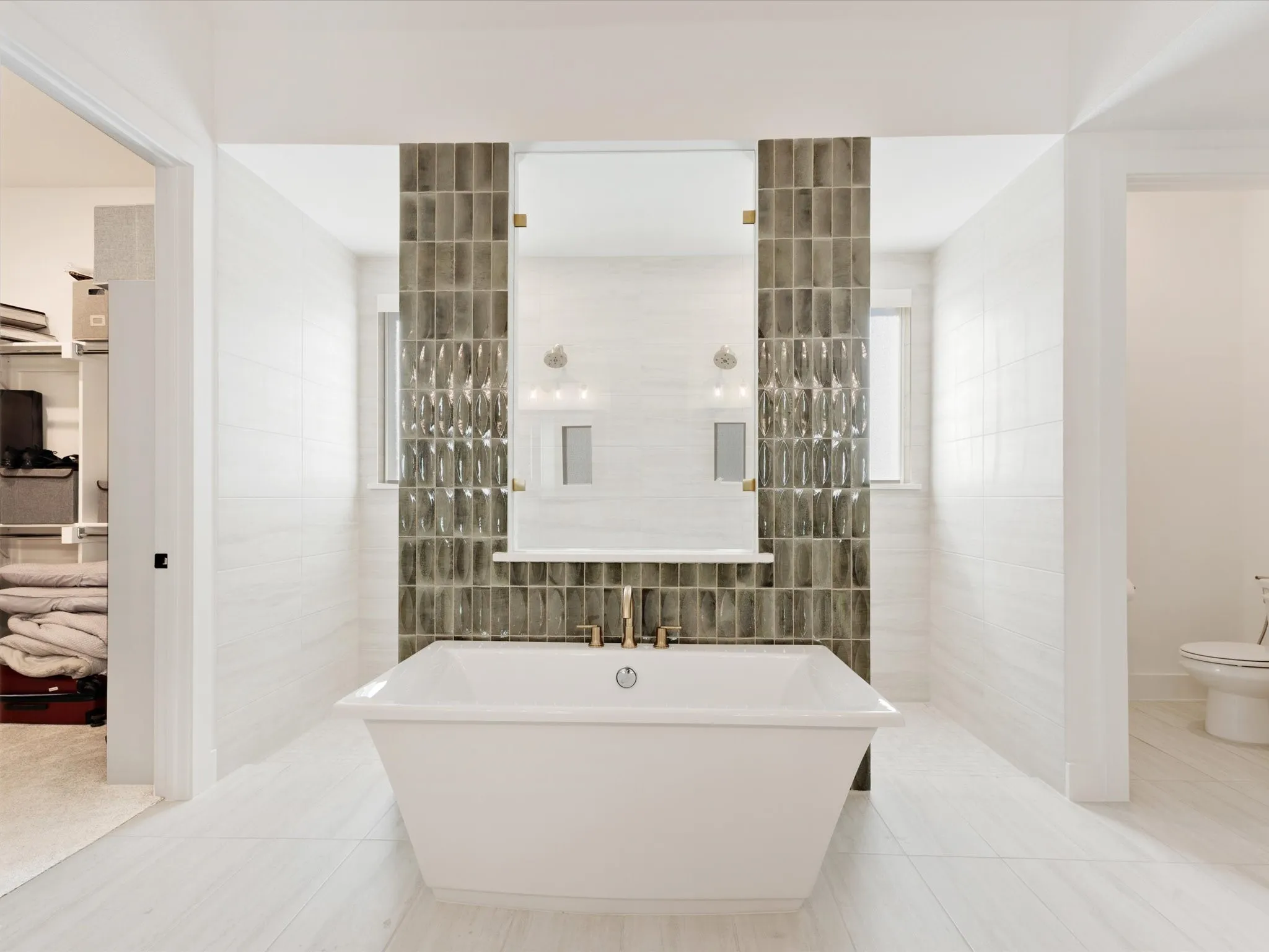  Primary Bathroom with a walk in shower, tile walls, a freestanding bath, light tile patterned floors, and connected bathroom