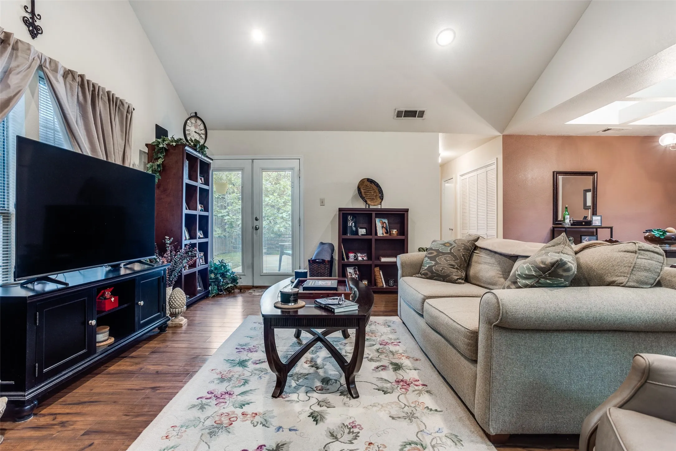 Double French doors lead to backyard.