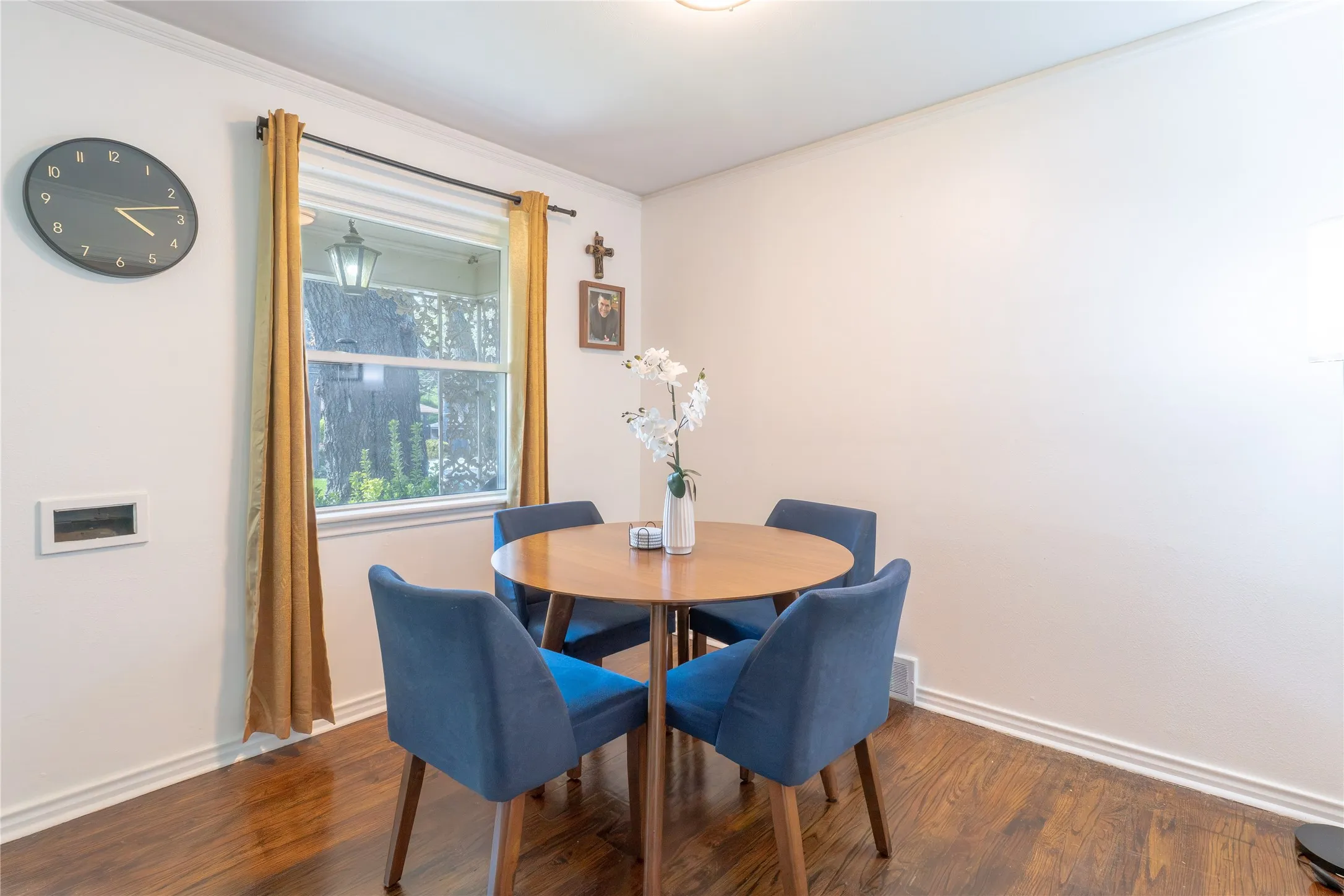 Dining room featuring dark wood-type flooring and ornamental molding