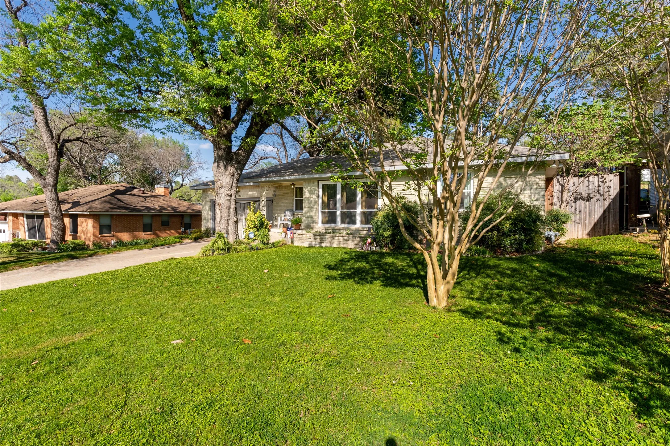 Single story home with a front yard, driveway, and a garage