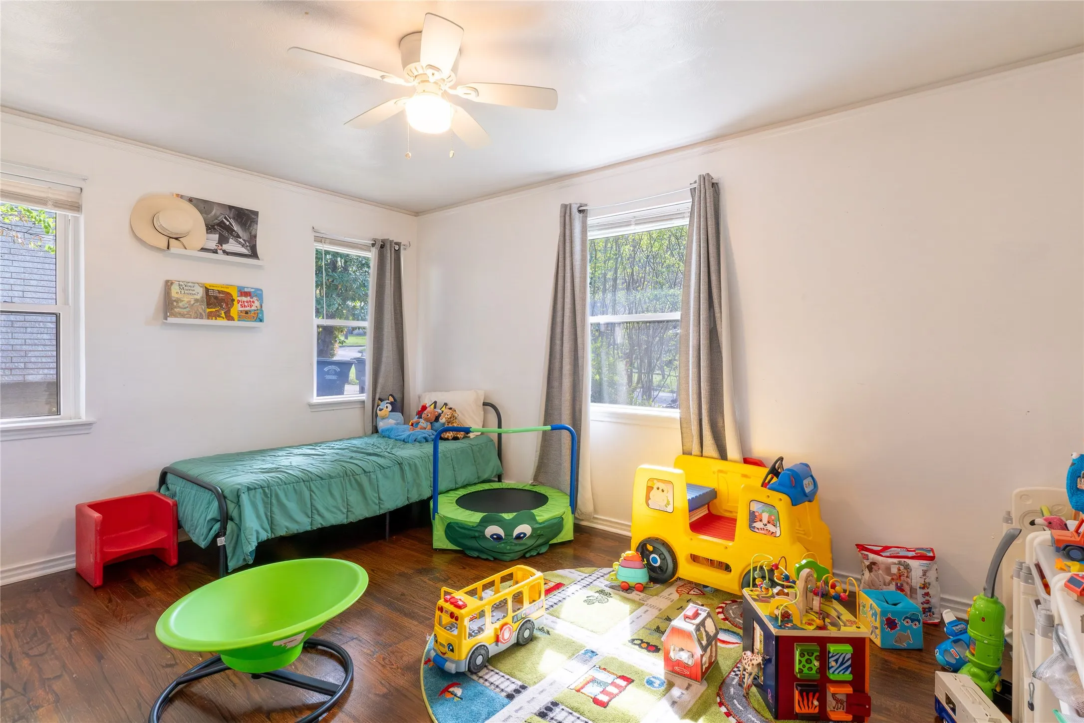 Bedroom featuring ceiling fan, dark wood-style flooring, and crown molding