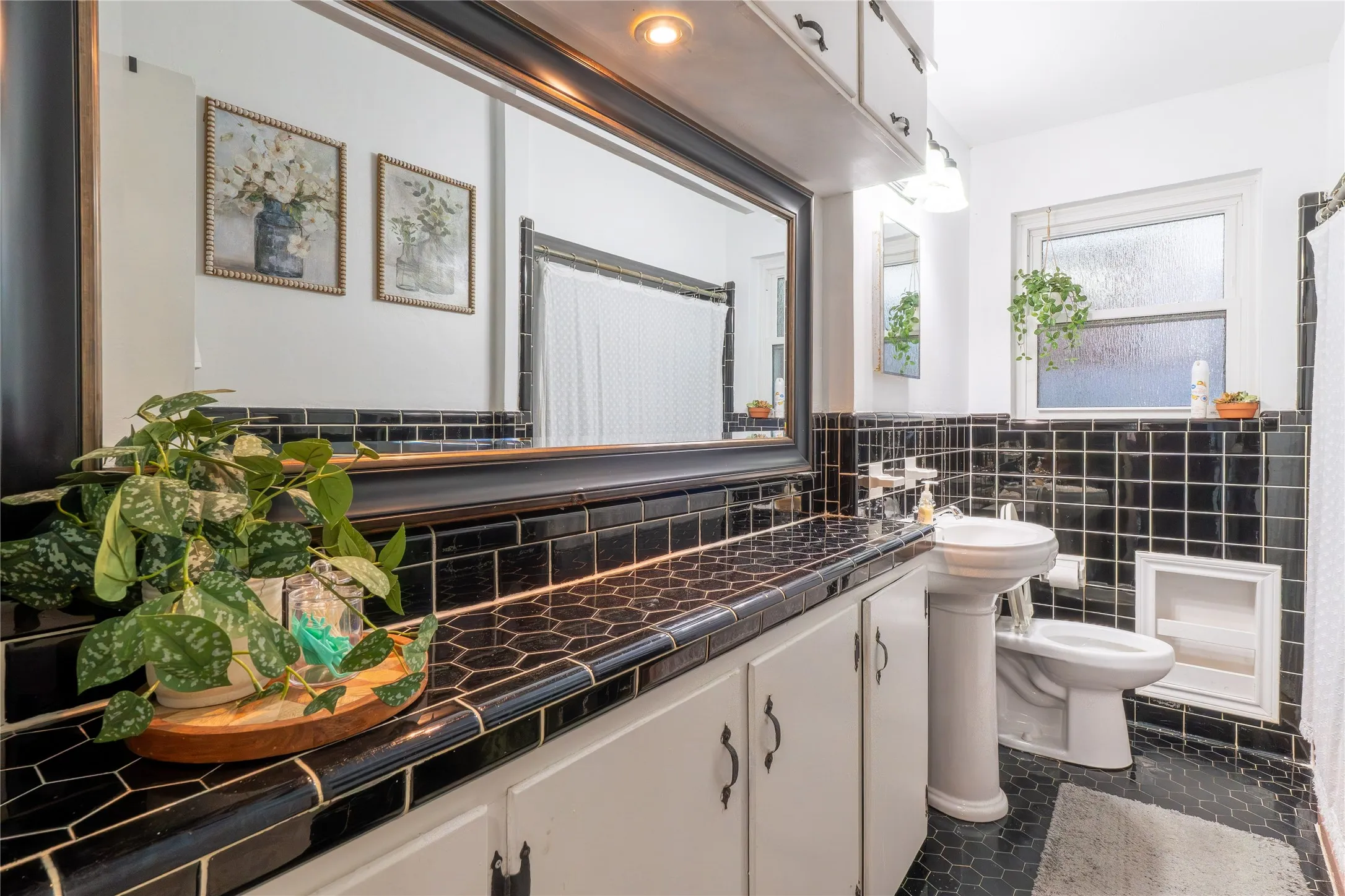 Bathroom featuring a shower, tile walls, and vanity