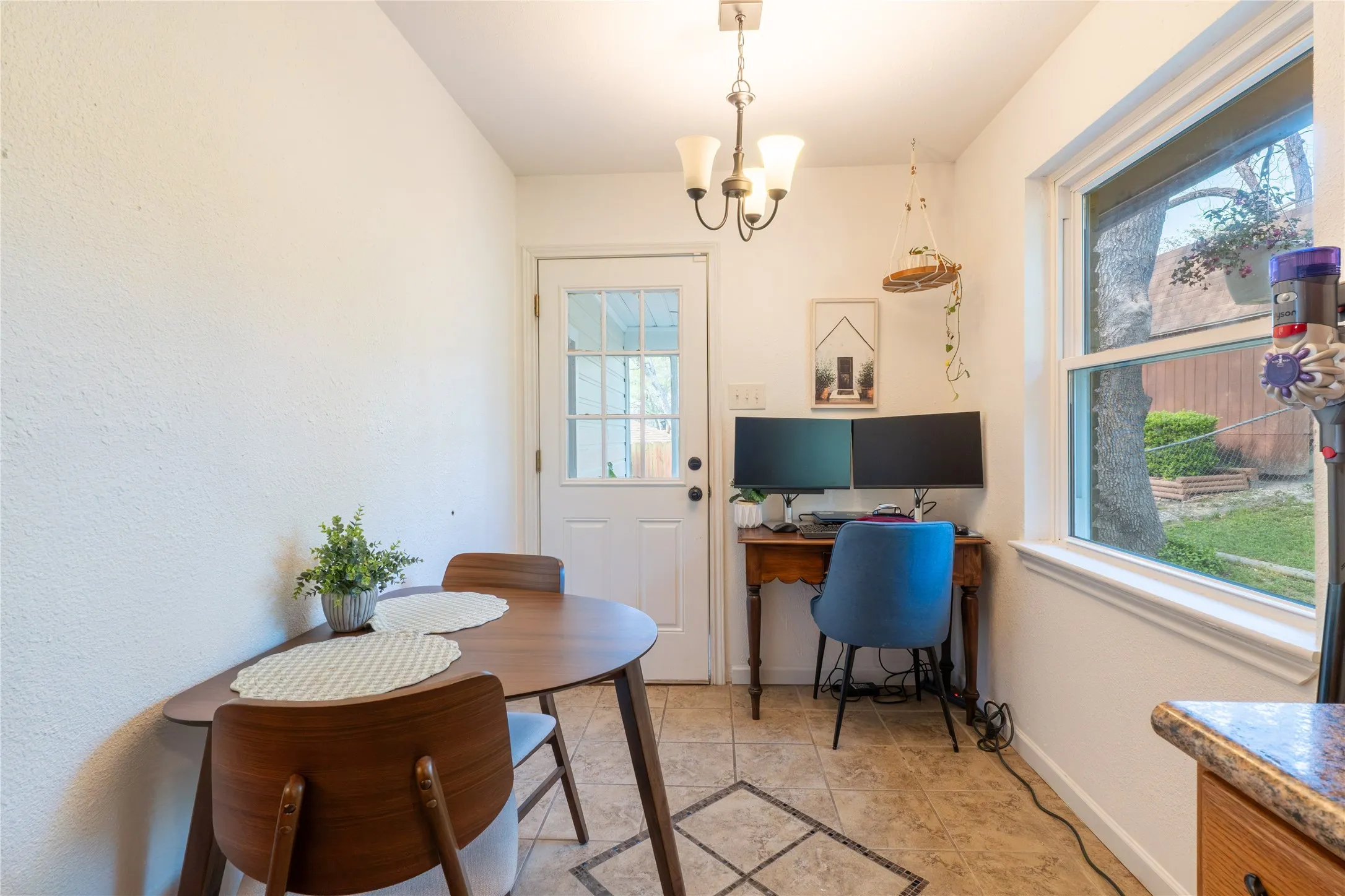 Dining space featuring a desk and hanging lights