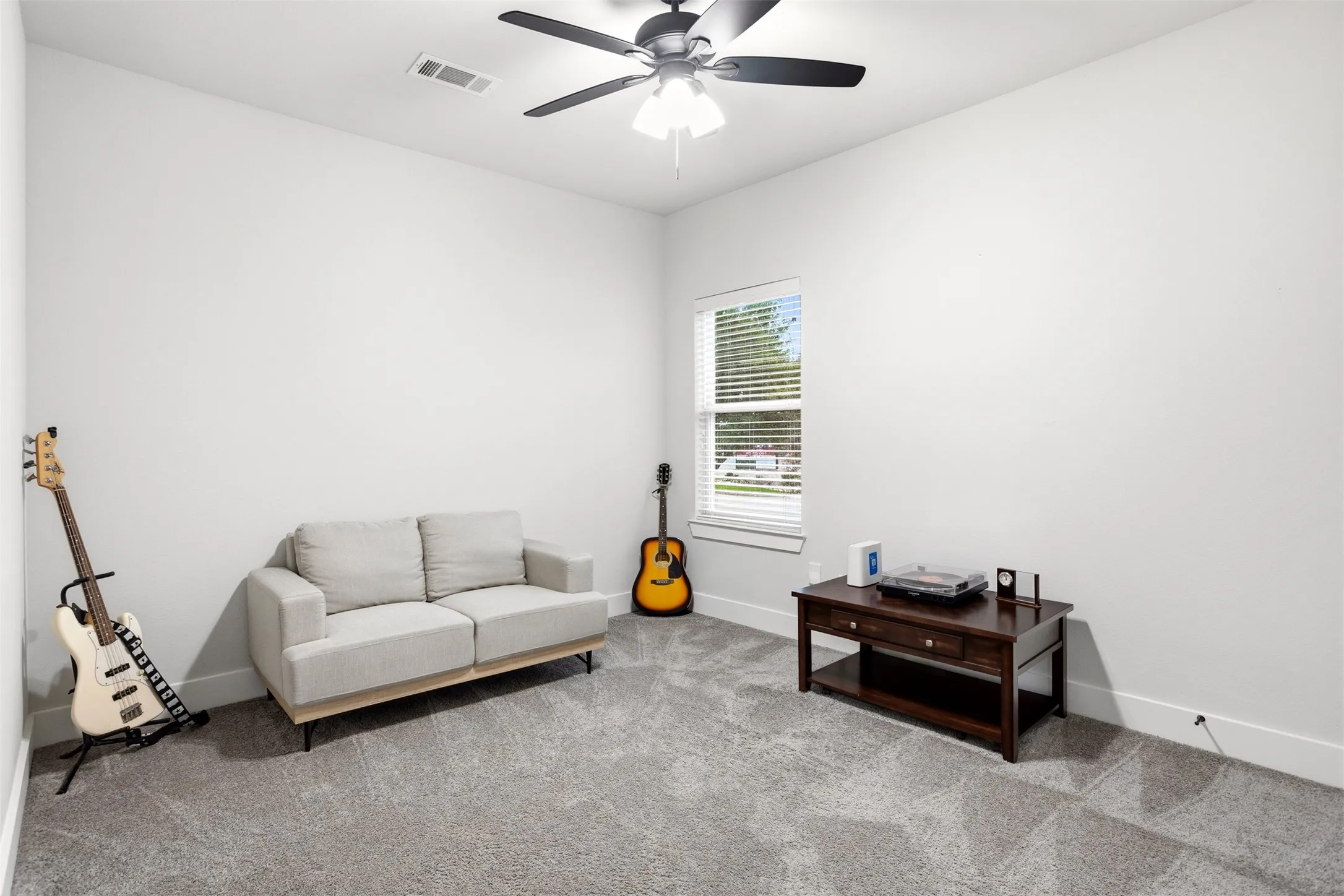 Sitting room with ceiling fan and carpet floors