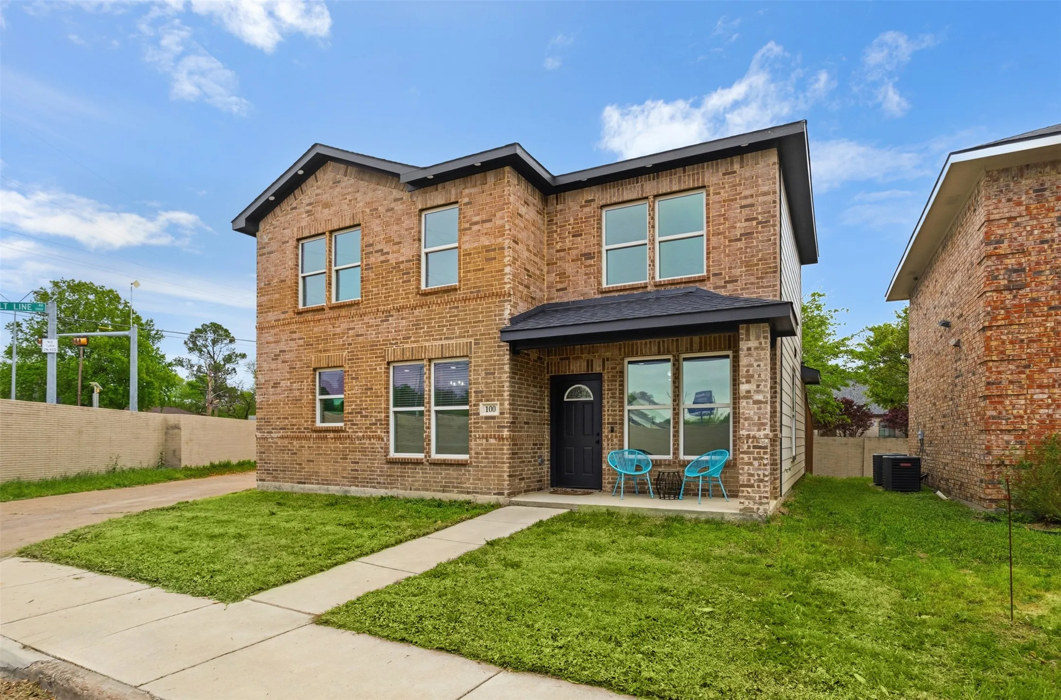 Traditional home featuring brick siding and covered porch