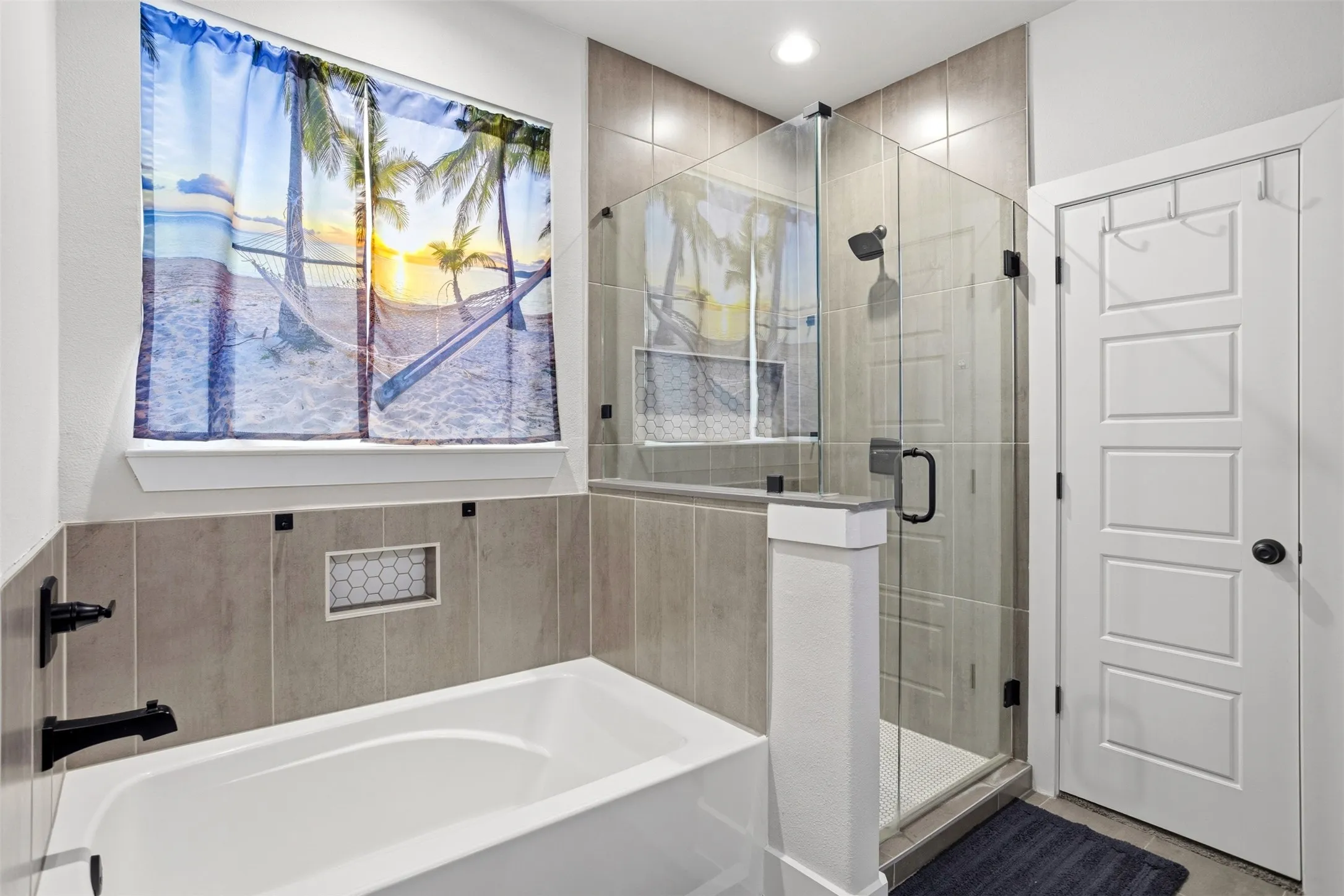 Bathroom with a stall shower and a garden tub