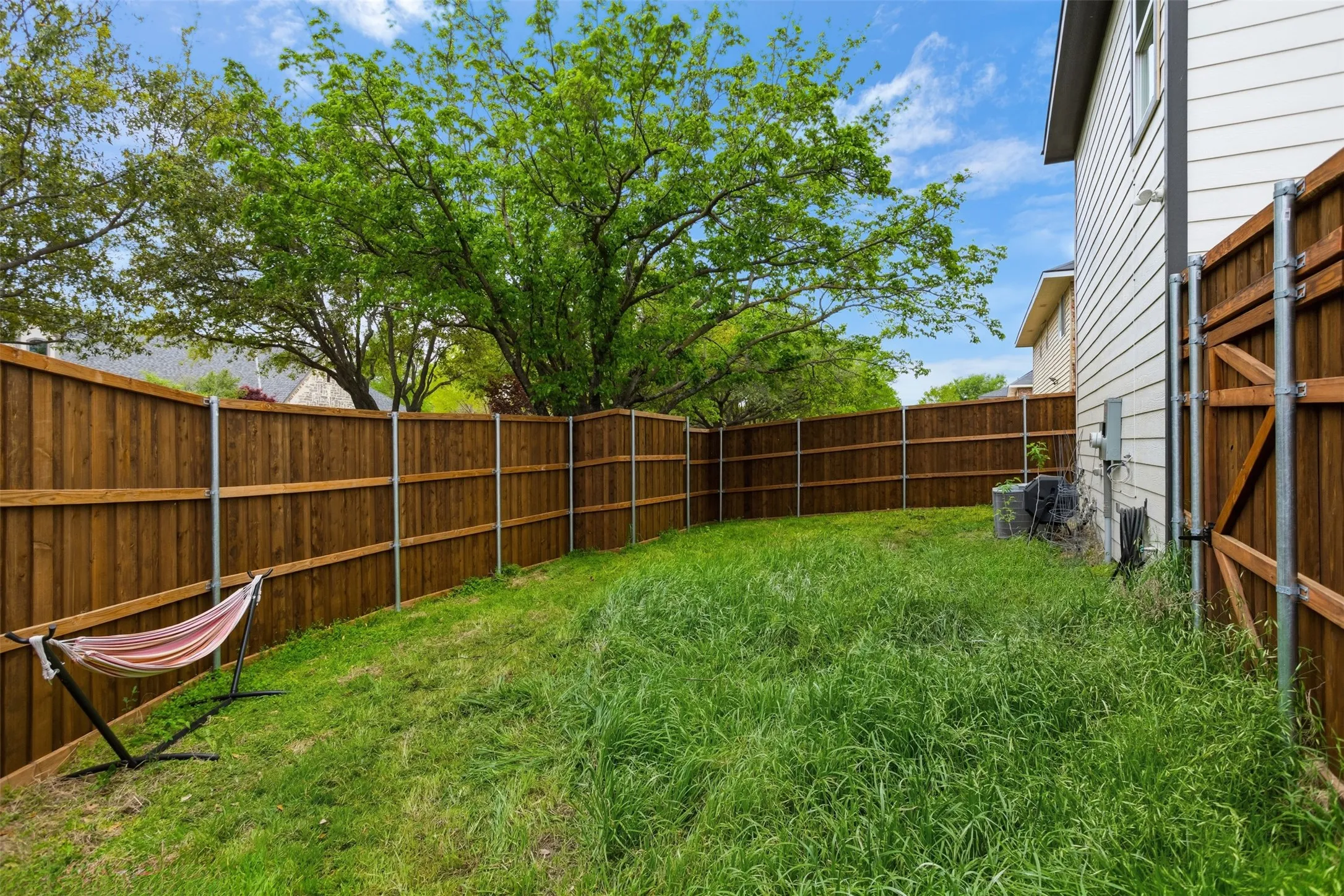 View of fenced backyard