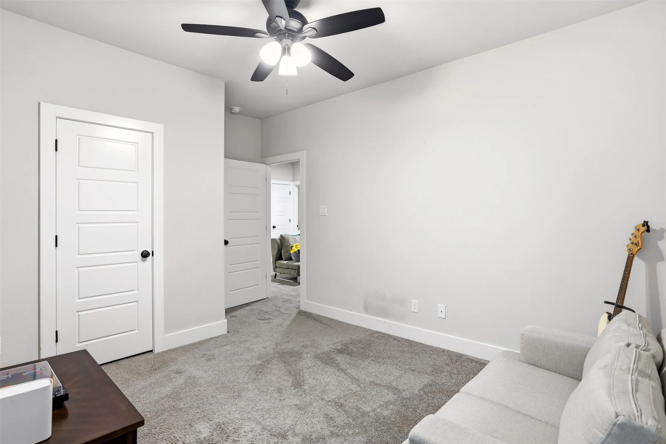 Unfurnished room with light carpet and ceiling fan