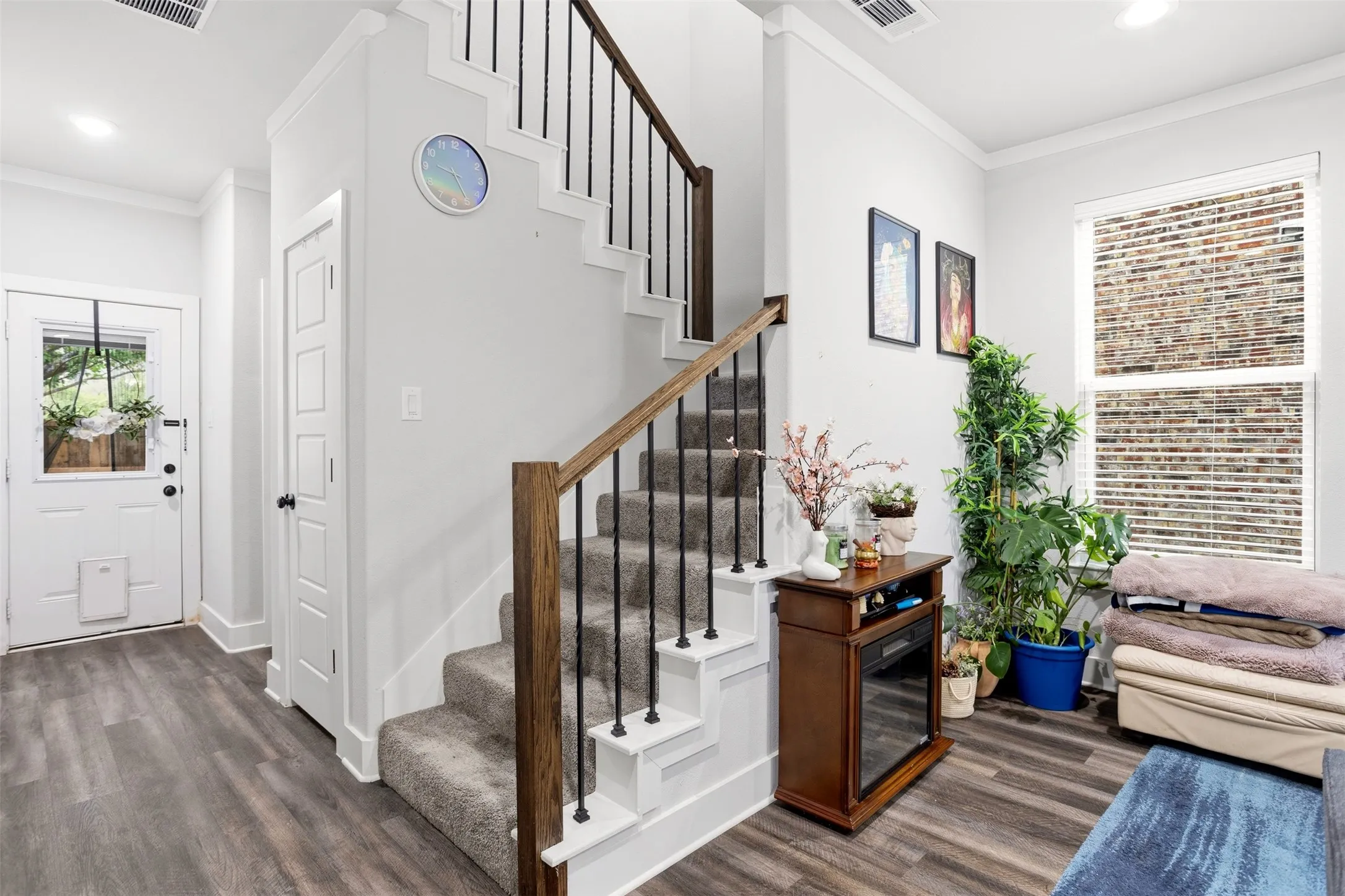 Foyer featuring crown molding, dark wood-type flooring, and recessed lighting