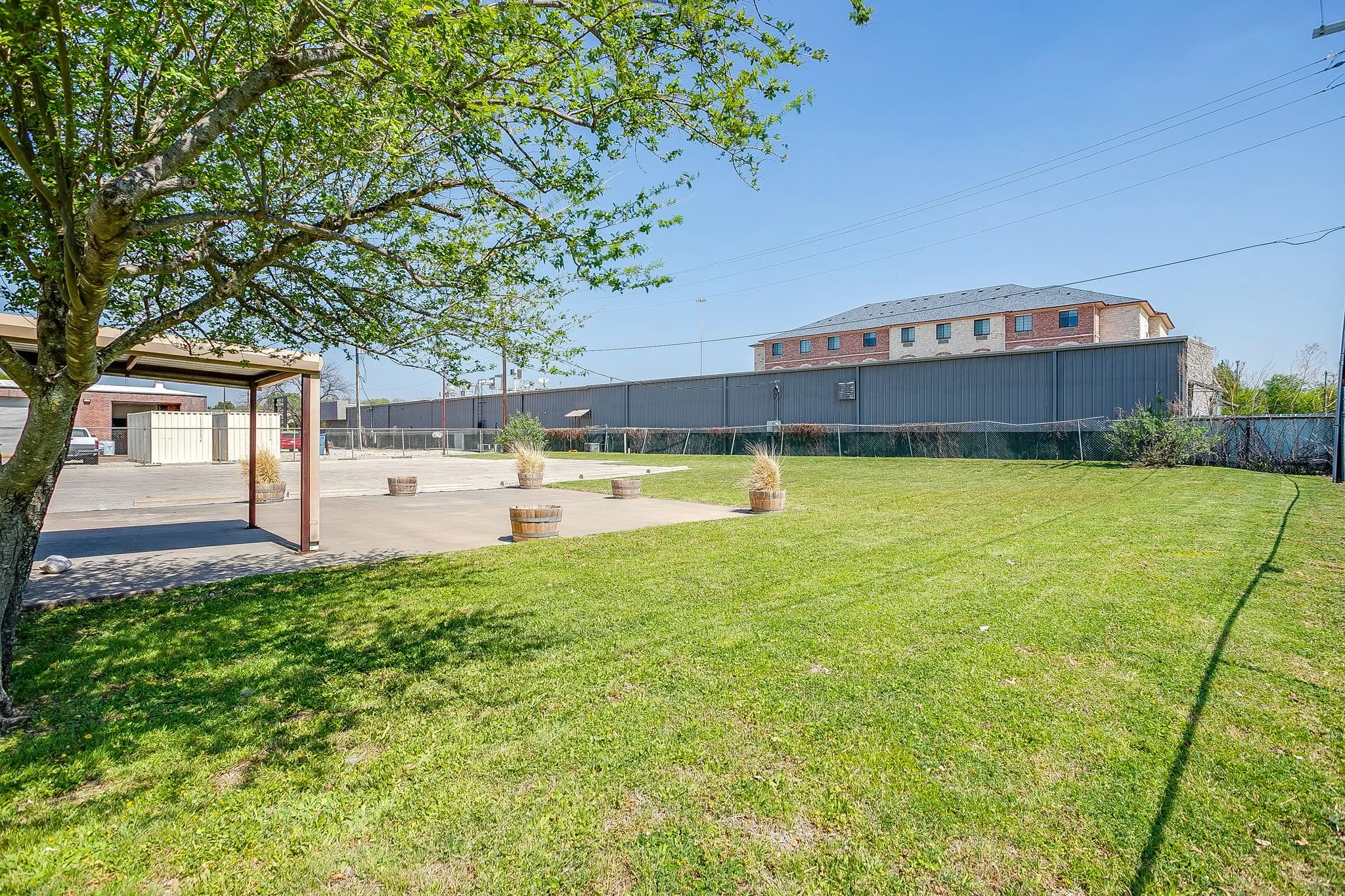 Envision some outdoor activities such as corn hole in this grassy space.