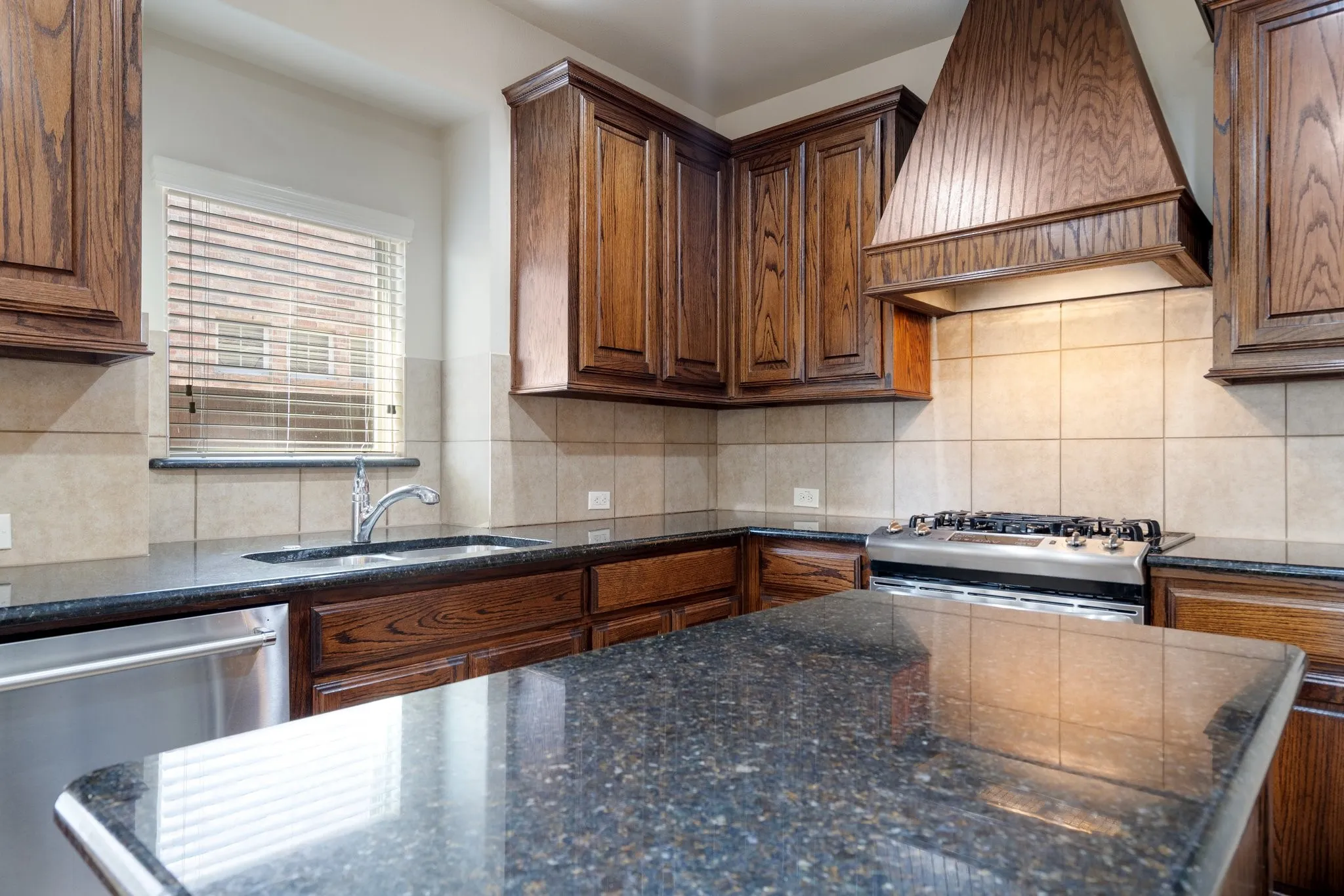 Sleek granite countertops and a matching center island
