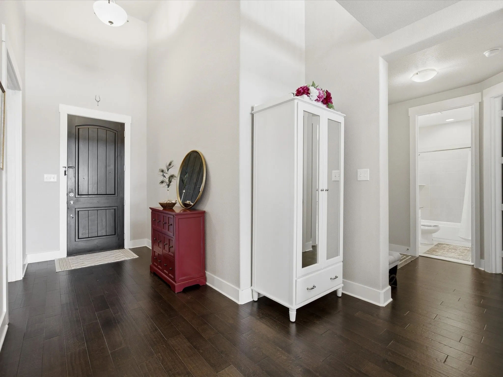 Foyer entrance featuring dark wood finished floors and a high ceiling