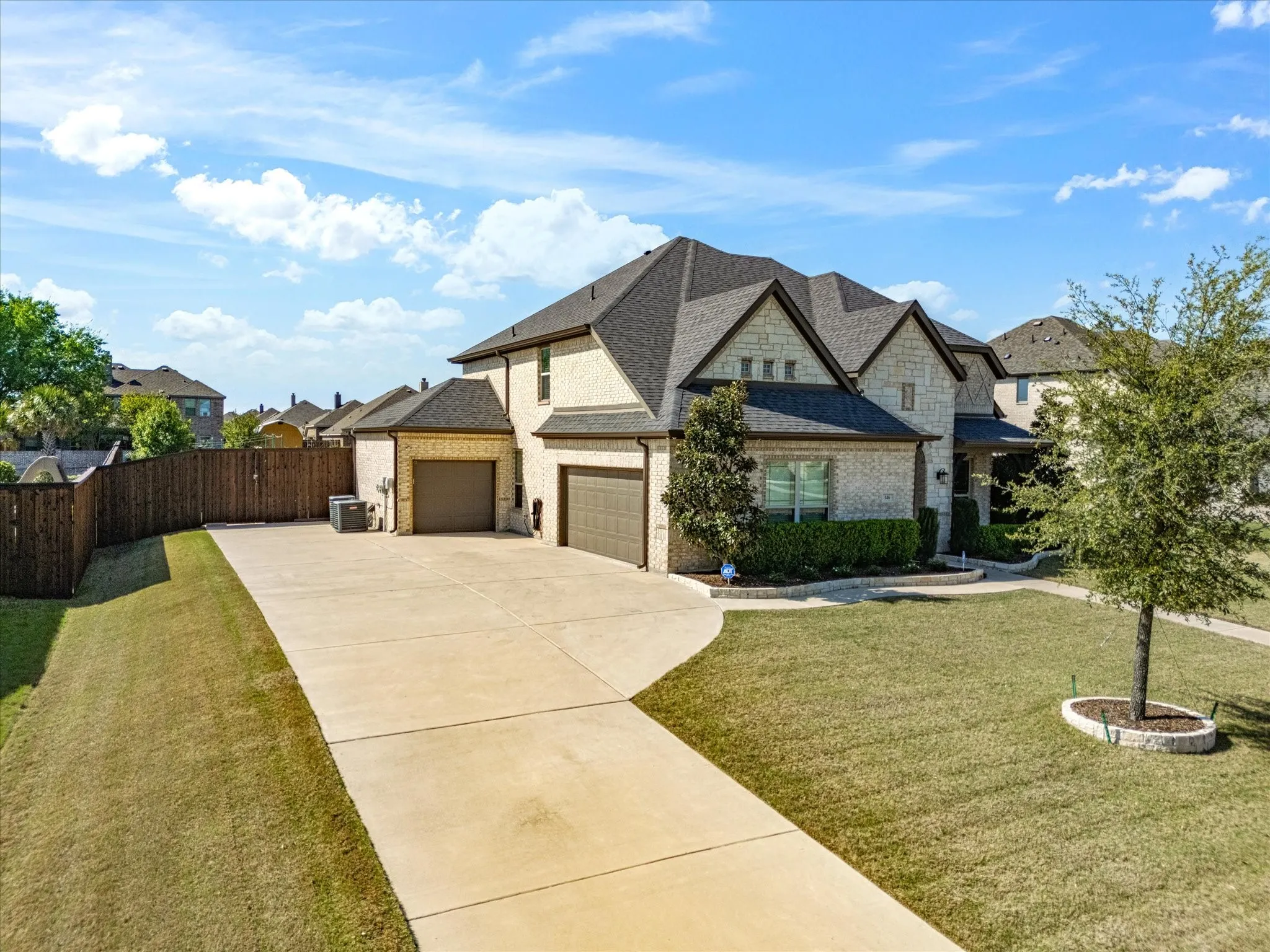 French provincial home featuring concrete driveway, a garage, roof with shingles, and brick siding