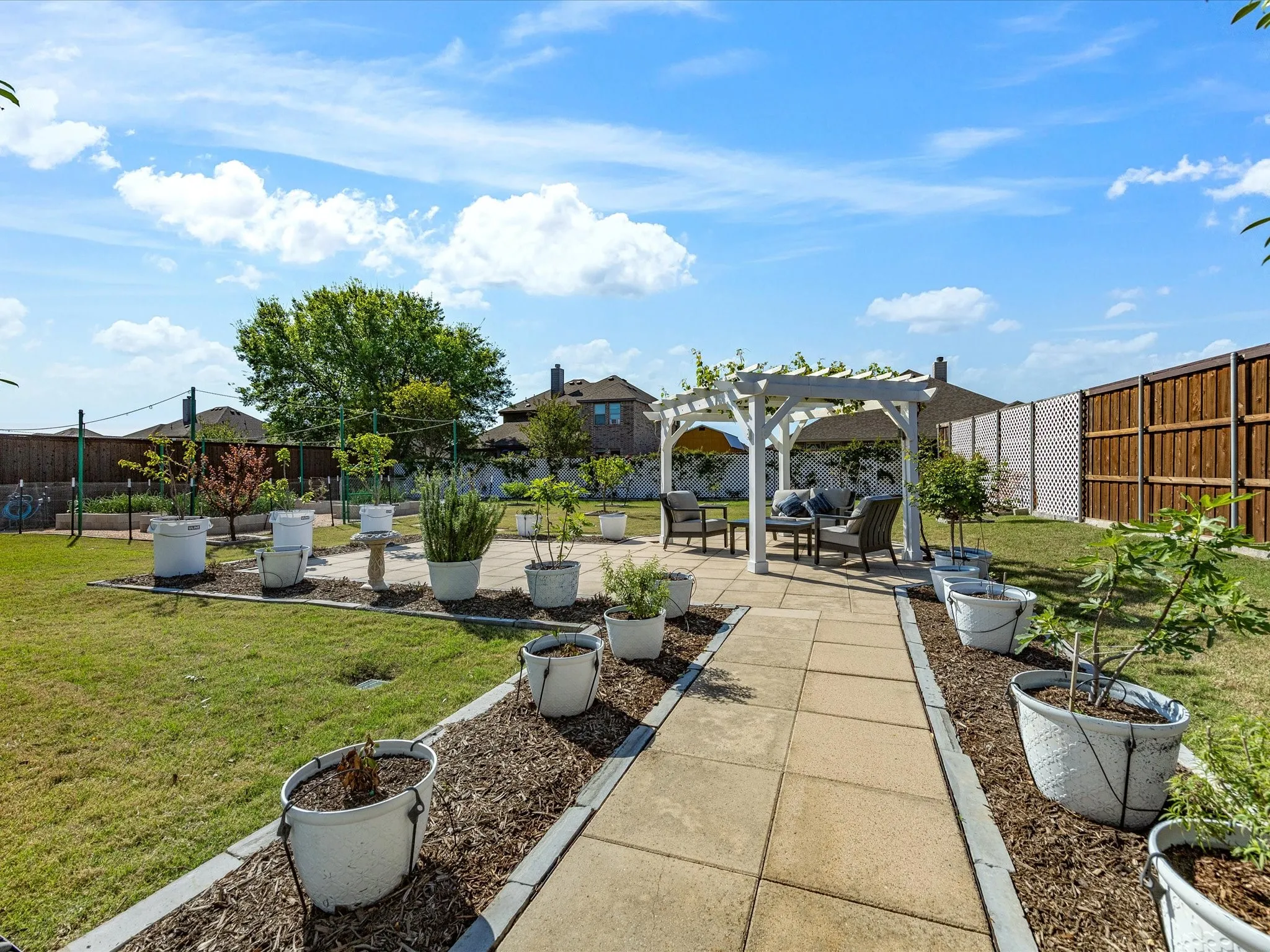 Fenced backyard with a patio, a pergola, and outdoor lounge area
