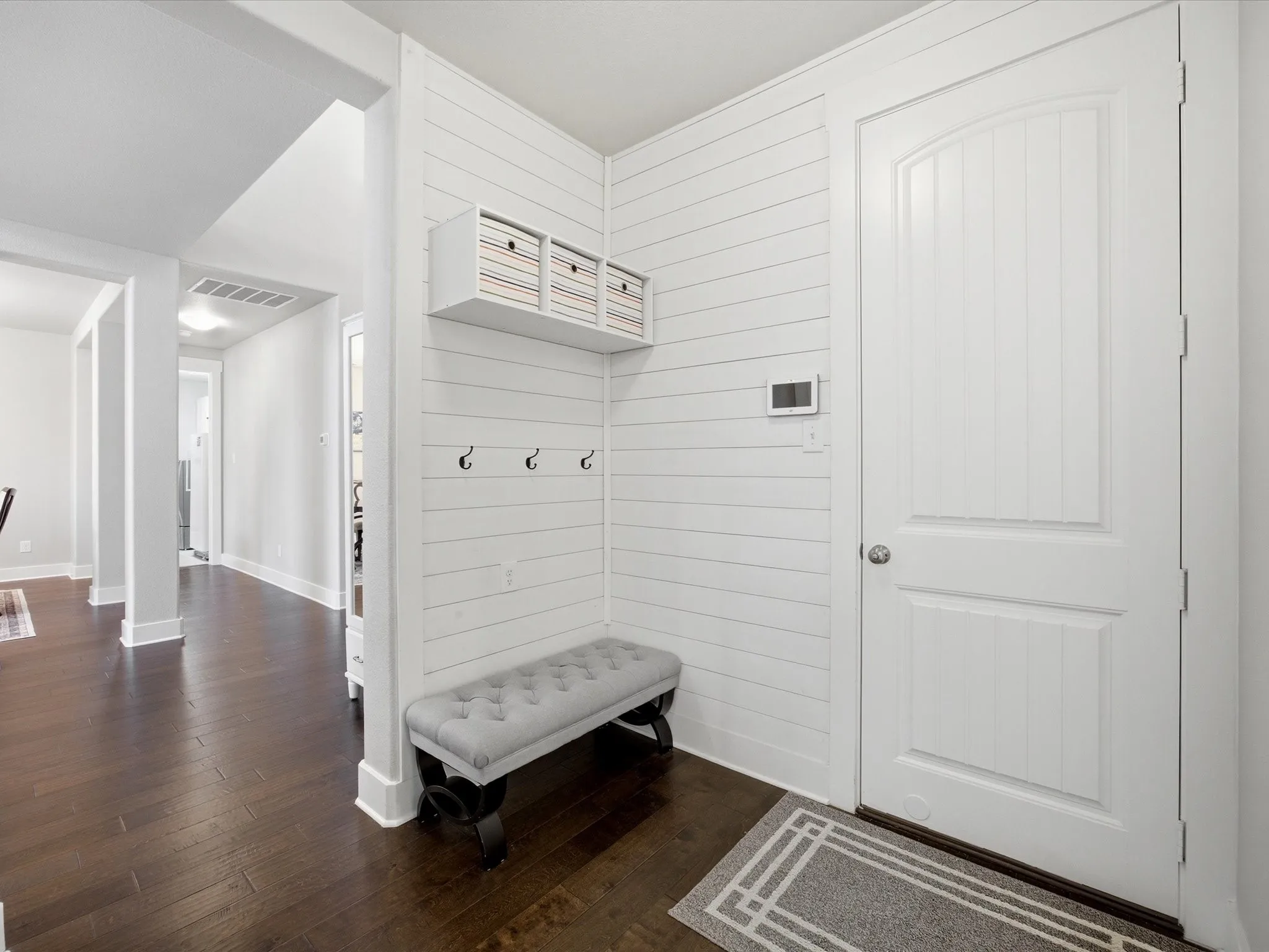 Mudbench with dark wood-style floors and baseboards