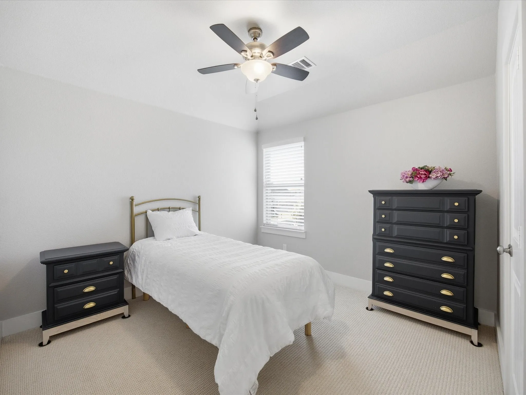 Carpeted bedroom featuring ceiling fan and baseboards