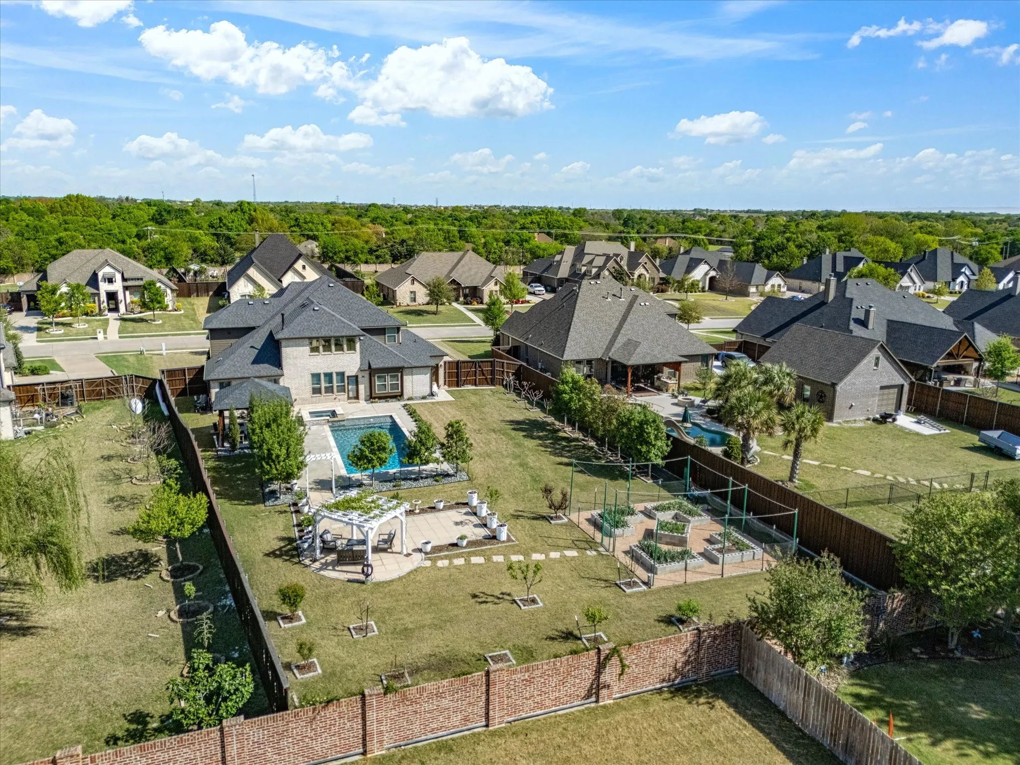 Aerial perspective of suburban area featuring a pool