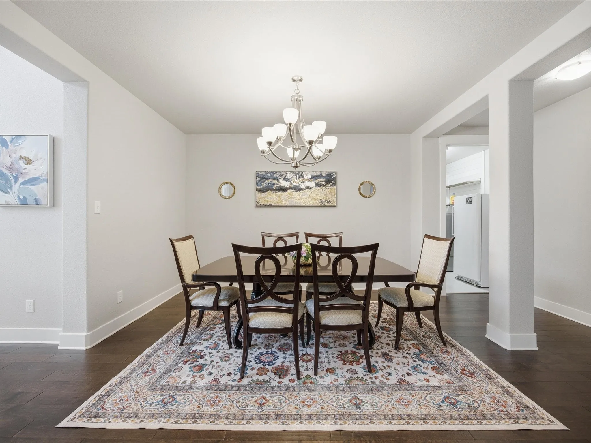 Dining room featuring dark wood finished floors and suspended lighting