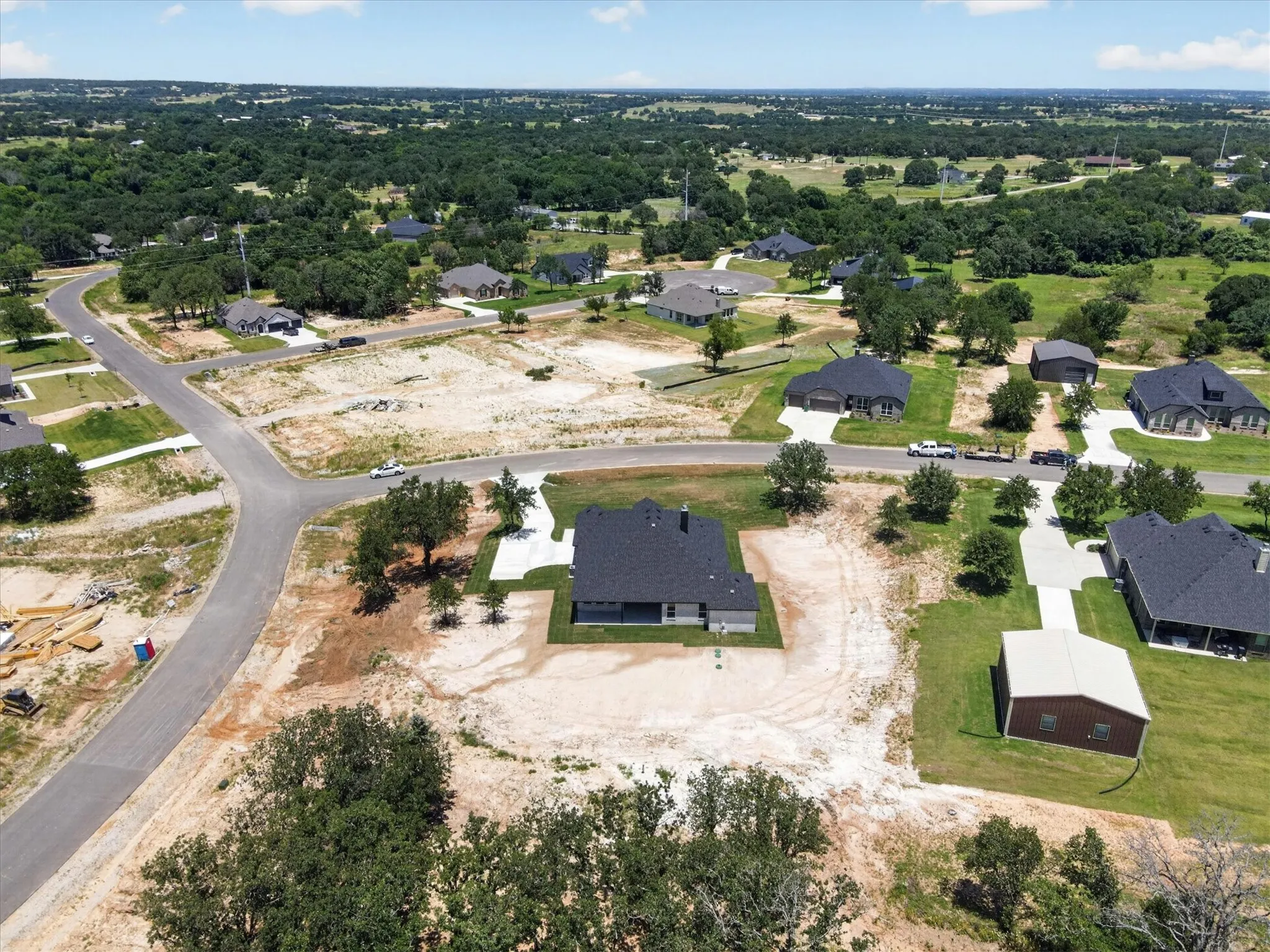 Newly constructed single-story residence featuring a dark shingle roof and light-toned exterior