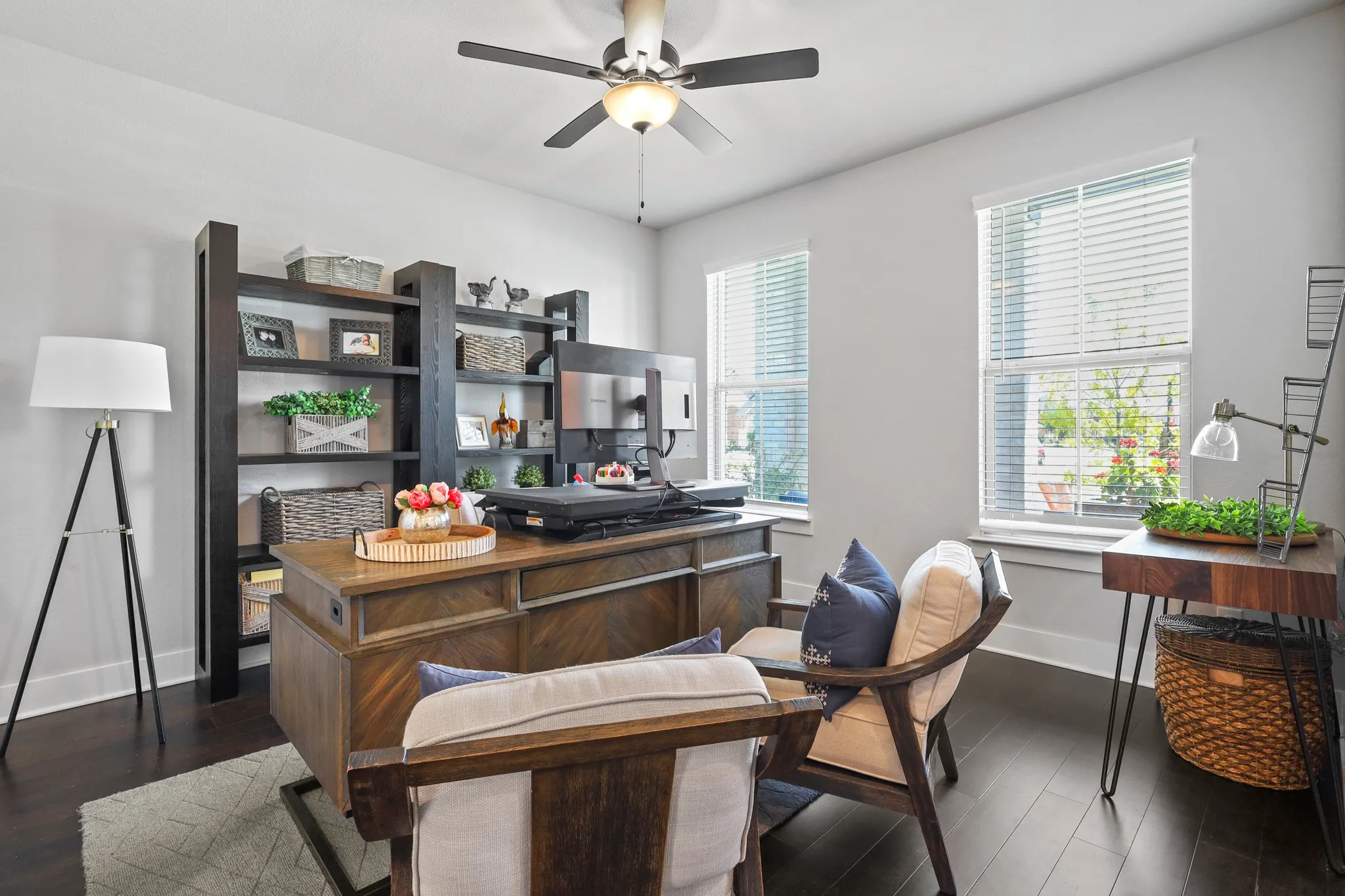 Home office featuring ceiling fan and dark hardwood / wood-style flooring