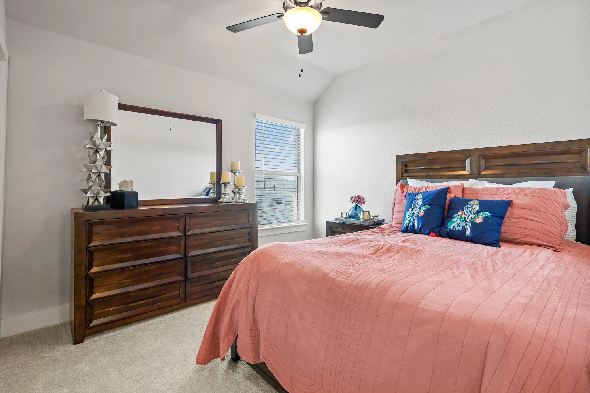 Bedroom featuring ceiling fan, light carpet, and lofted ceiling